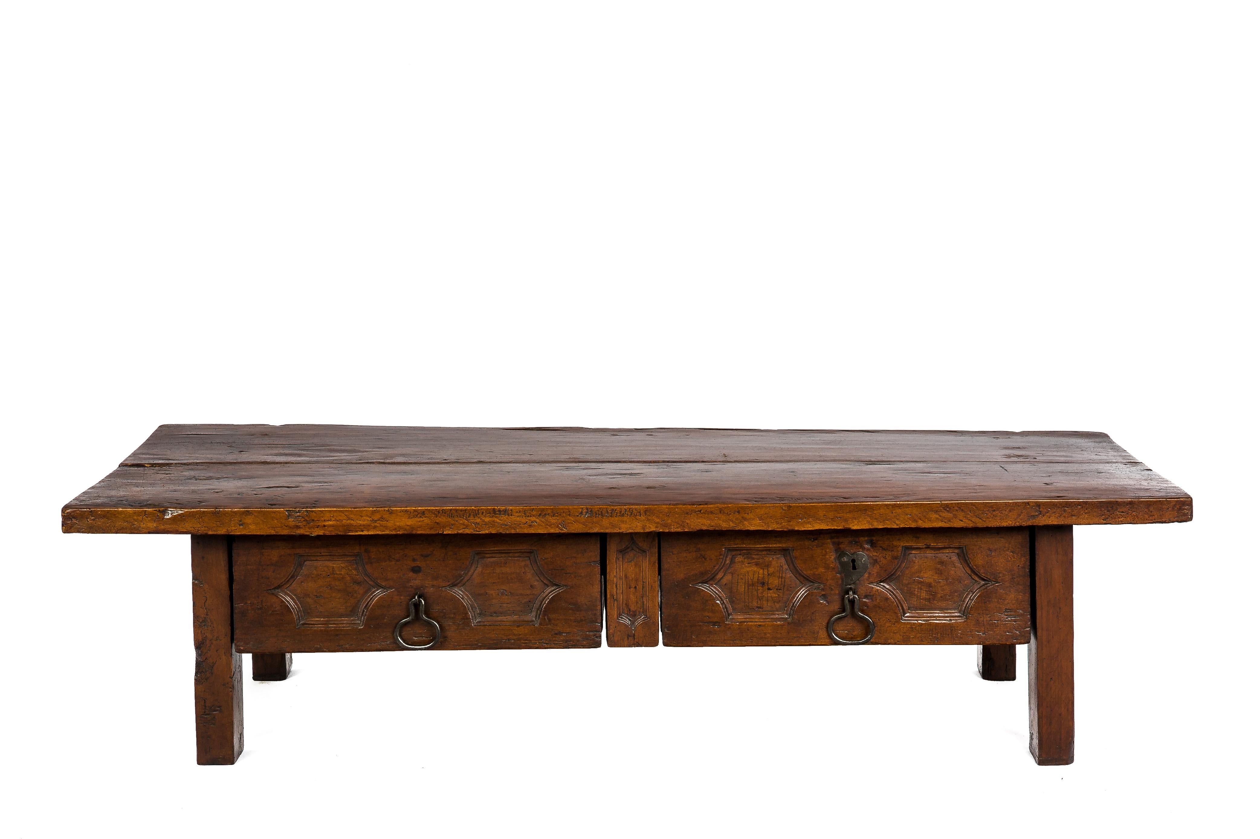 This beautiful rustic coffee table originates in Spain and dates circa 1750. 
The tabletop is made of two boards of chestnut 1,5 inches thick. The coffee table has two drawers with hand-forged steel drawer pulls. The drawer fronts are decorated