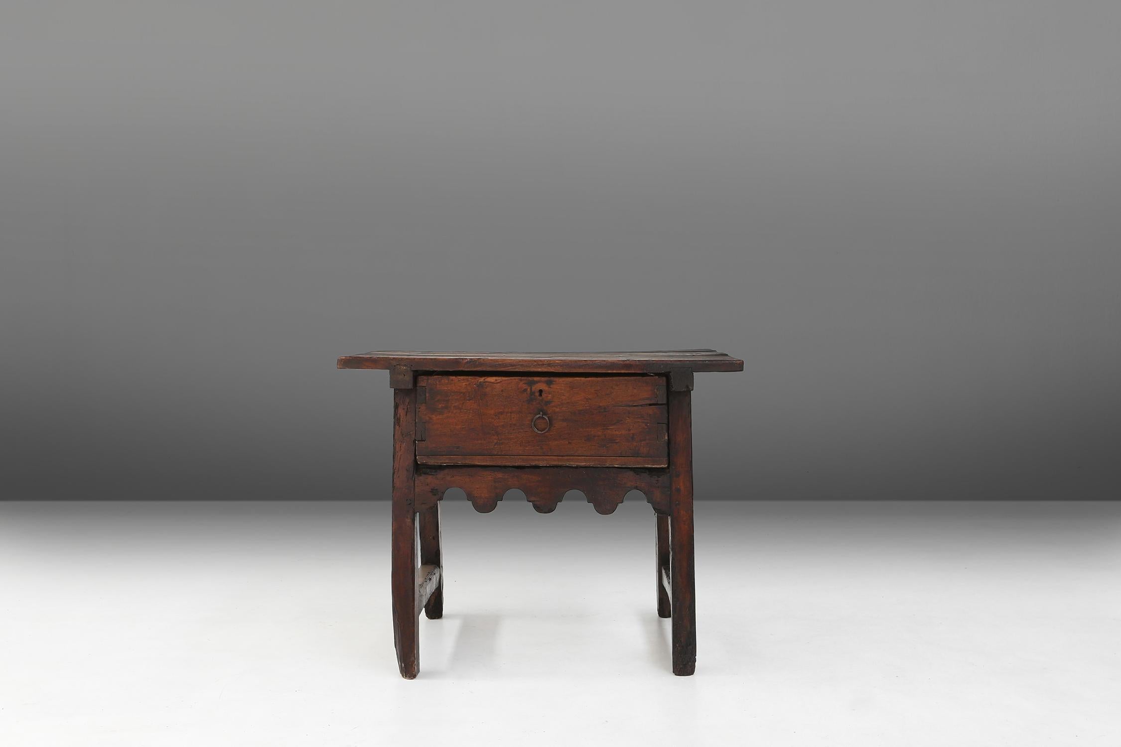 This extraordinary 18th century table used to be a counter table in a Spanish store or market stall. You can still see the notch in the table top where the money fell in. The table has a beautiful patina on the wood, which is a testament to the time