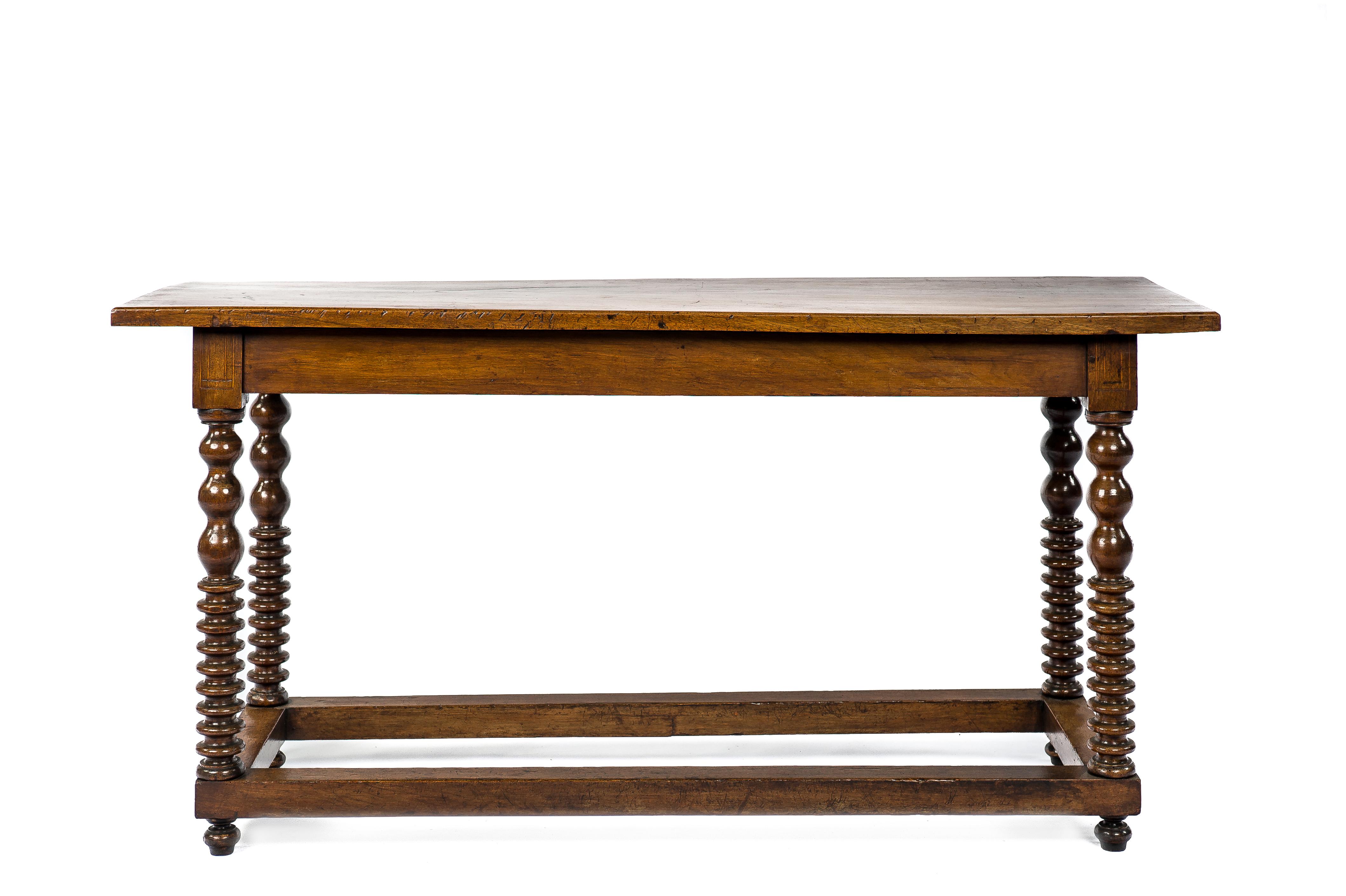 A rare Spanish walnut side table or wall table that was made in Spain in the mid 18th century. This table is unique because of its intricately turned legs. The legs' top block features a double square light wood inlaid pattern. The legs are joined