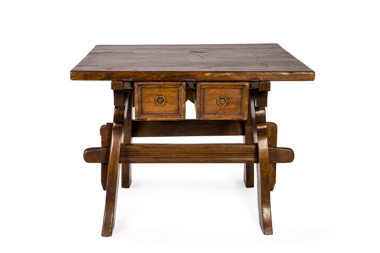 A beautiful bankers or merchants table that was made in Switzerland around 1750. The table has a square 1.57 inch thick top made in solid walnut. The planks were joined by steel S-shaped interconnectors visible on the sides. The table stands on