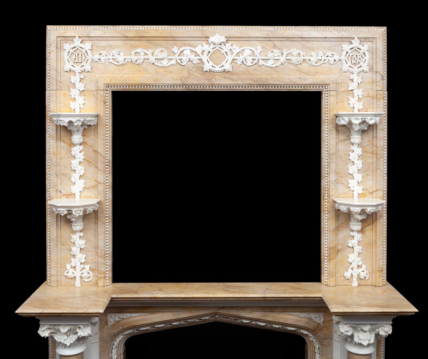 A magnificent and rare antique Statuary and Sienna marble fireplace. The lower half with full rounded Sienna columns on Statuary pilasters and with highly carved capitals, each one different. The arched opening decorated with a trail of carved