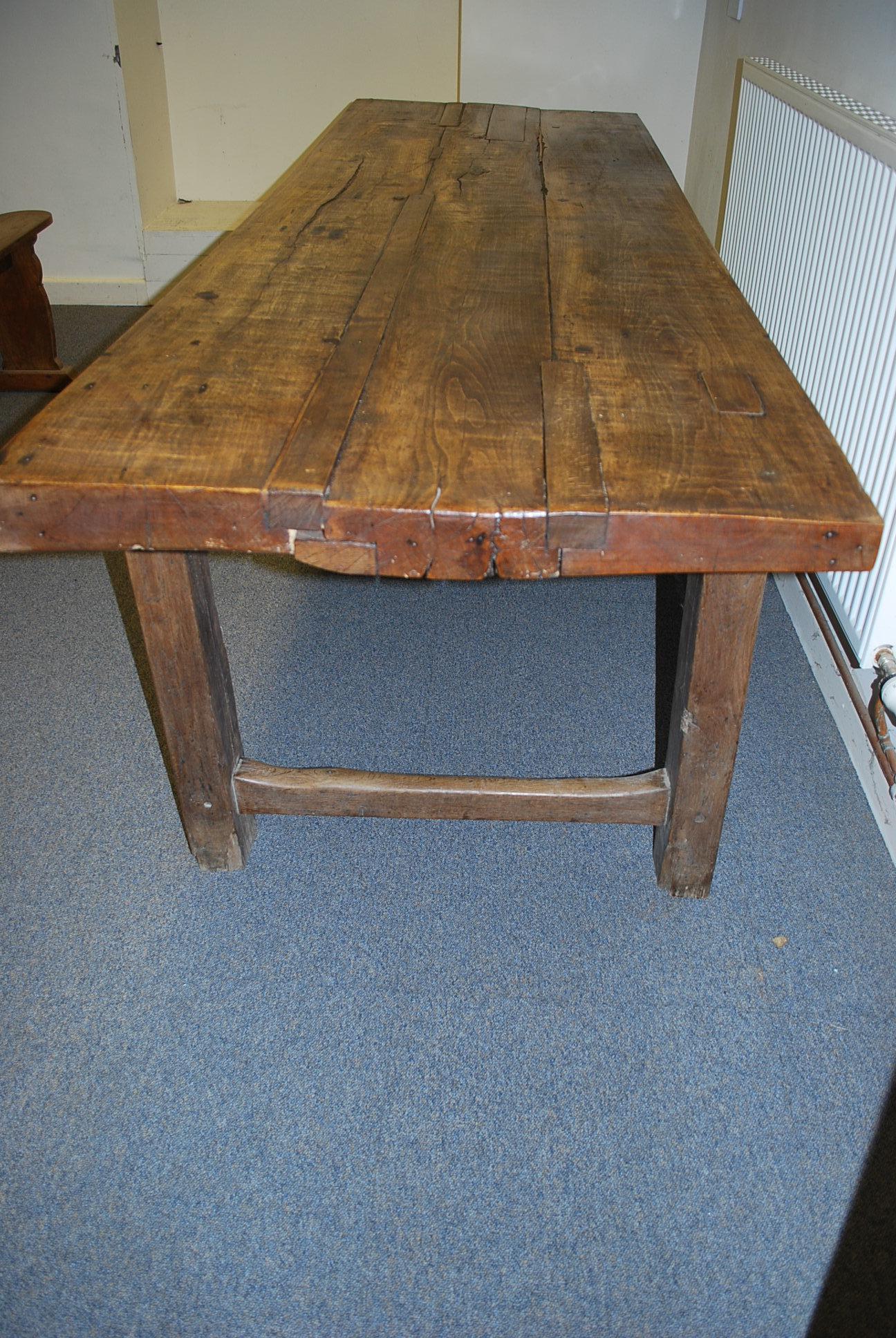 A rare 18th Century French farmhouse table with a nice thick top and excellent color and patination. Lots of old patches to the top and worn stretchers at you would expect from a table of this age. A real statement piece with plenty of character,
