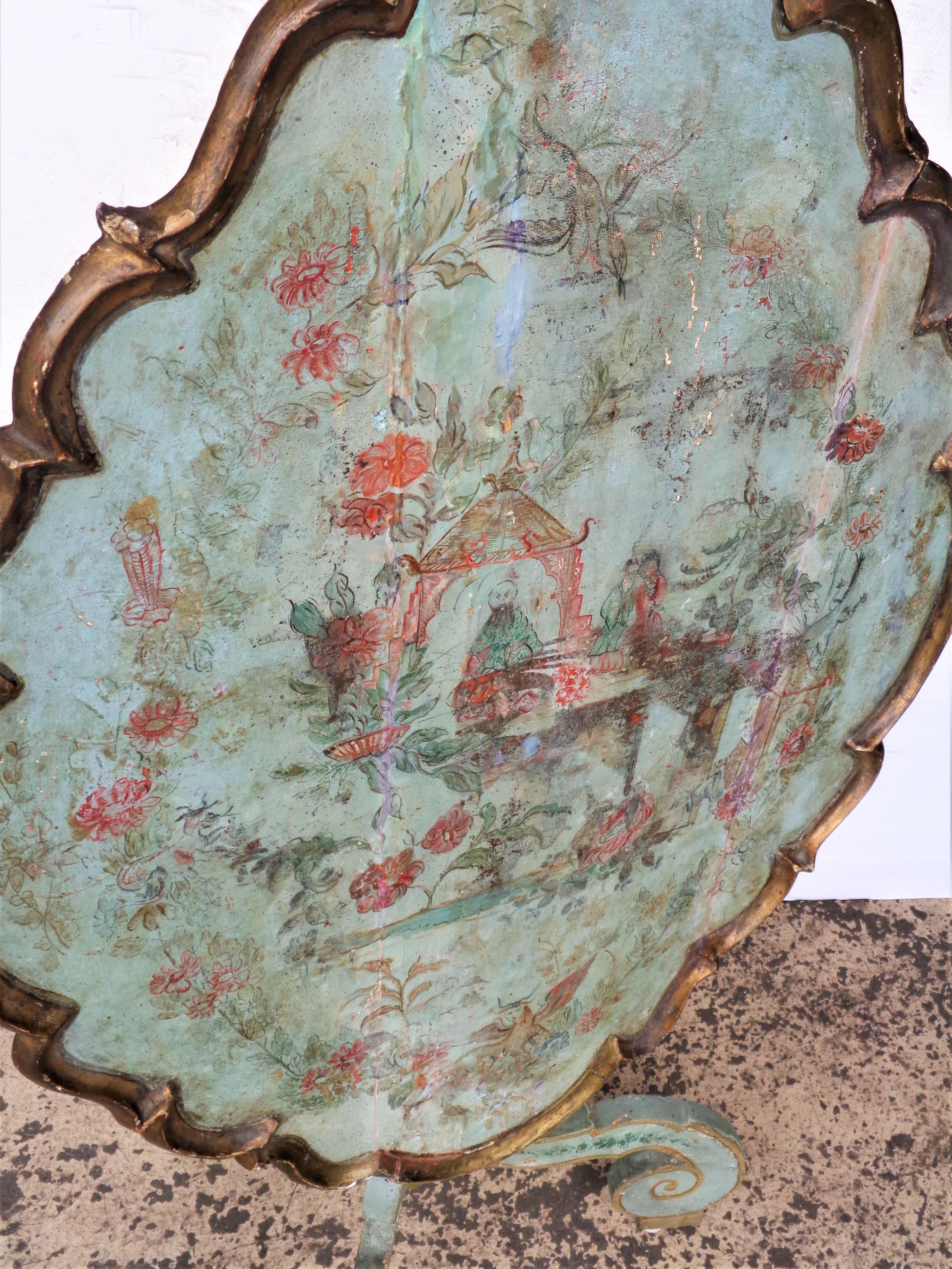 Antique 18th century Venetian painted tilt top table in aged worn old surface w/ extraordinarily magical hanfd painted done chinoiserie decoration to scalloped shaped wood top. Measures w/ top down 33