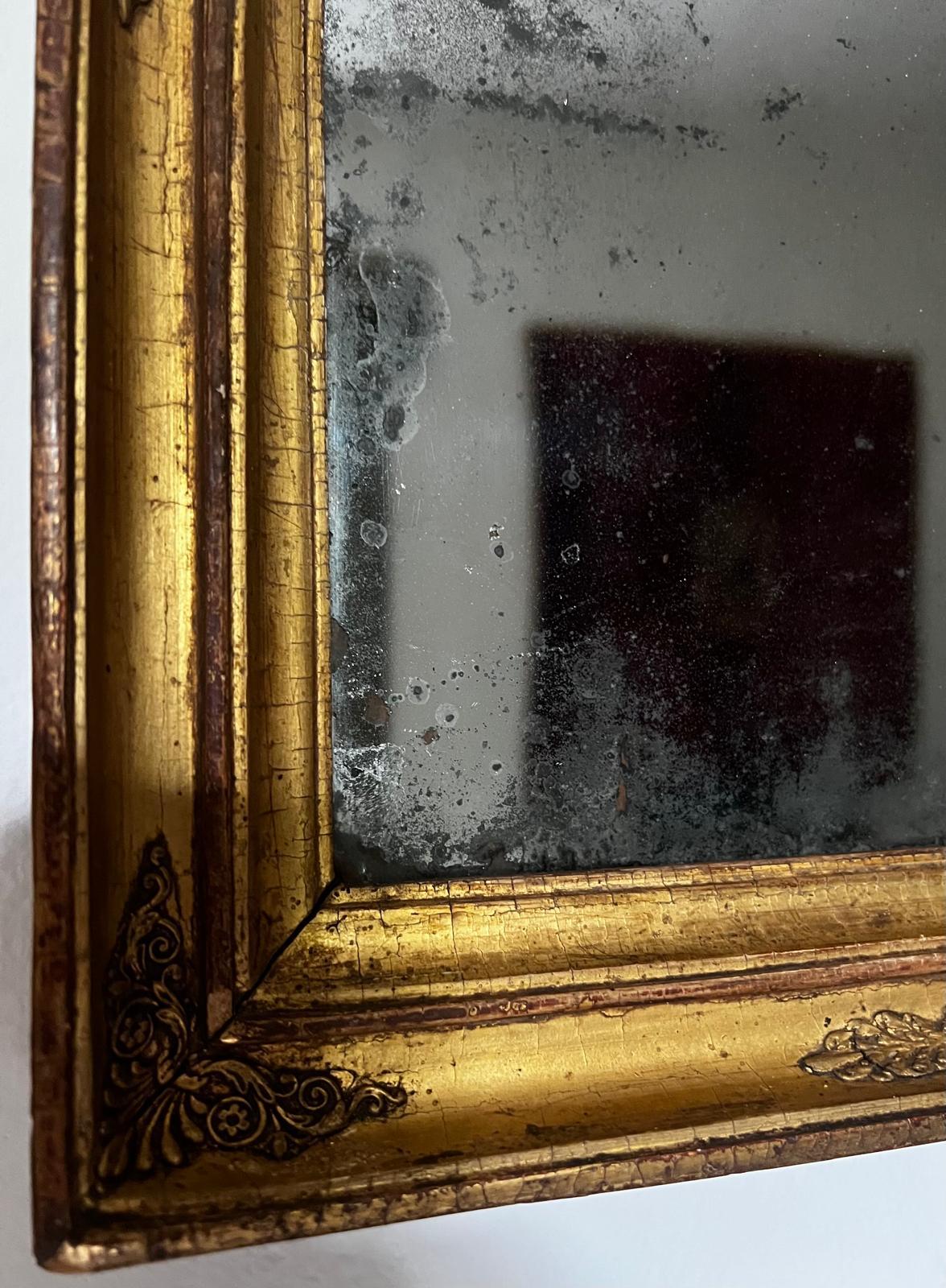 ..“Magic Mirror on the wall, who is the fairest one of all?”..
A truly wonderful and very intricate mirror with the original wood panel to hold the mirror in place in the back. The gold gilded frame has very fine ornaments and is very delicate.