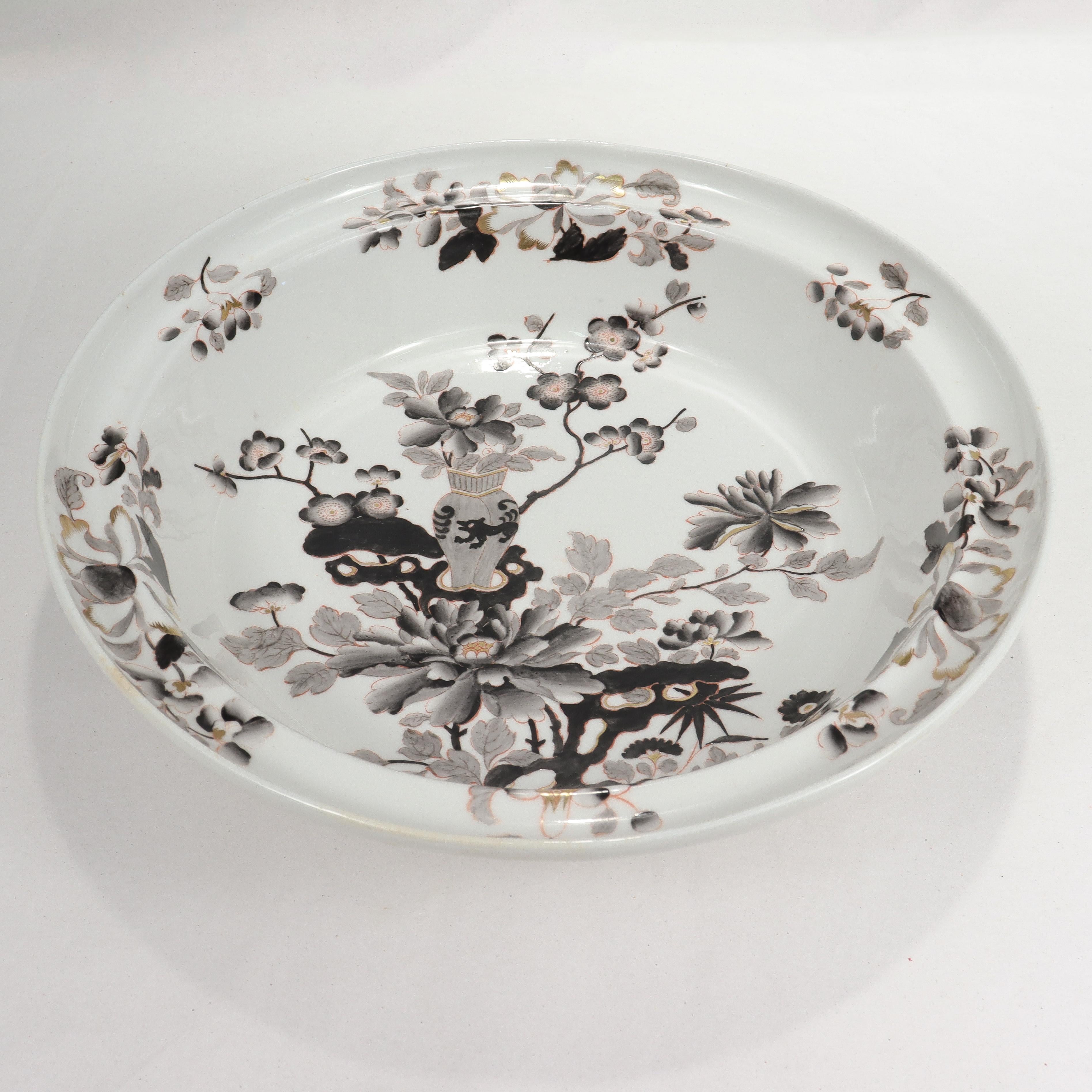 A fine antique English porcelain bowl or basin.

Attributed to Worcester. 

Decorated throughout with grey and black floral Chinoserie decoration with gilt highlights.

With a few paper labels to the base - an antique one that reads