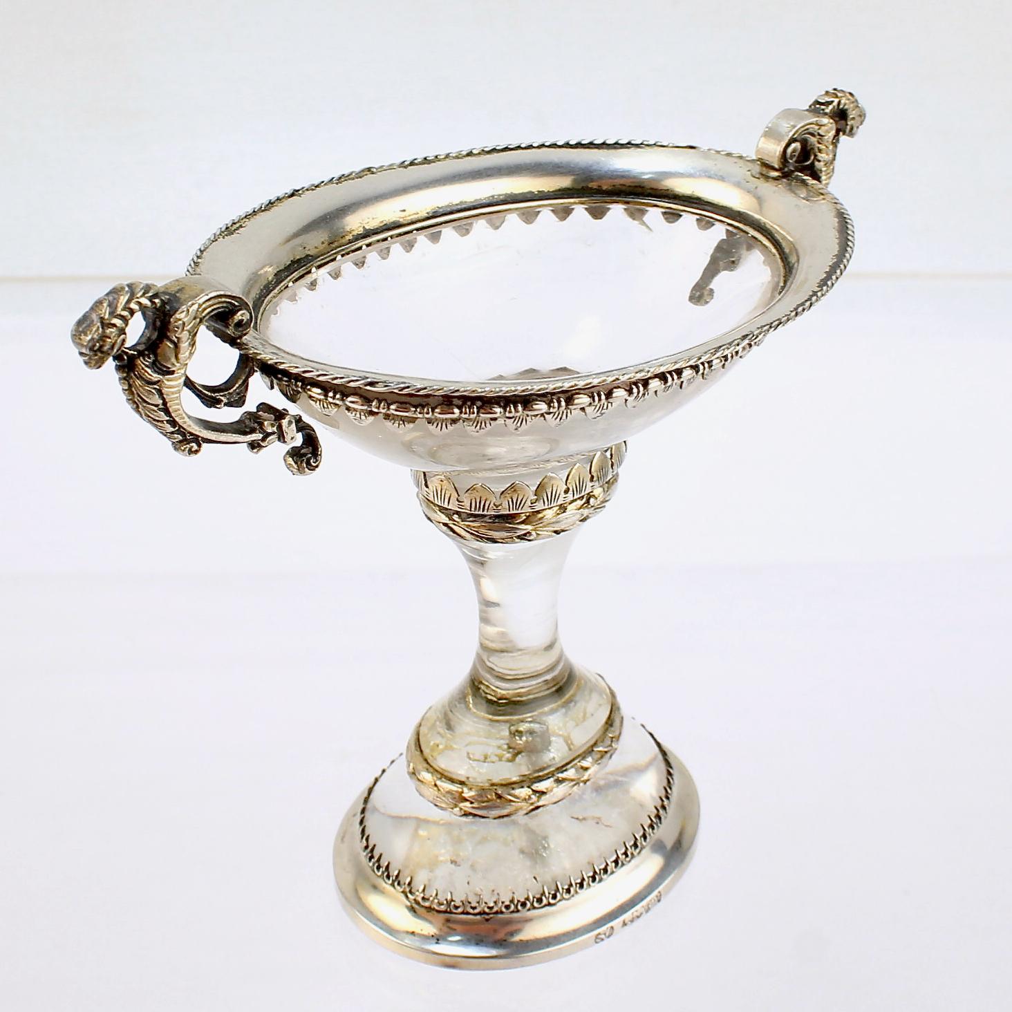 A fine antique Austrian salt cellar or miniature tazza.

Comprising 3 carved and polished rock crystal sections.

Mounted with ornate silver mounts - the top section having 2 dragon handles.

Simply an amazing antique rock crystal objet