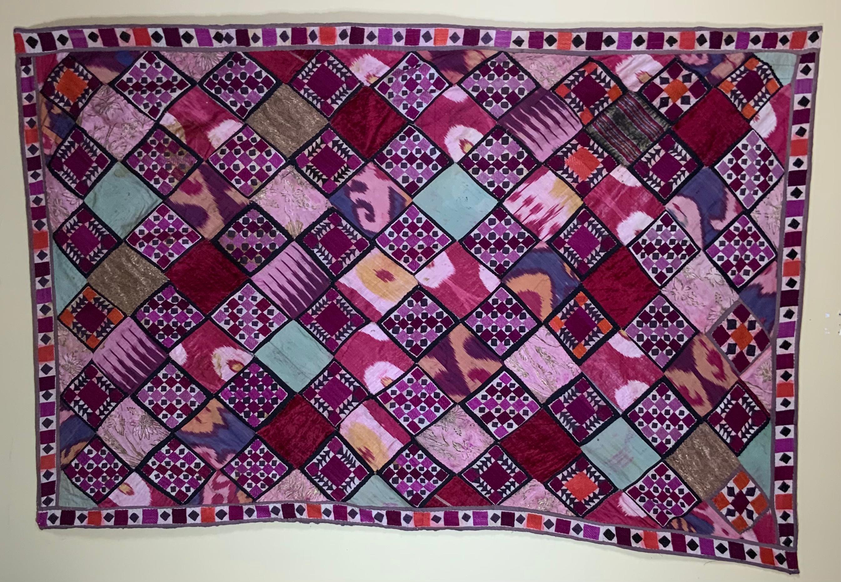 Antique Uzbek wall hanging made of combination of hand embroidery Suzani squares, silk Ikat, antique velvet and other textile all together with decorative Suzani border to become beautiful and intriguing nomadic piece of hand made work.