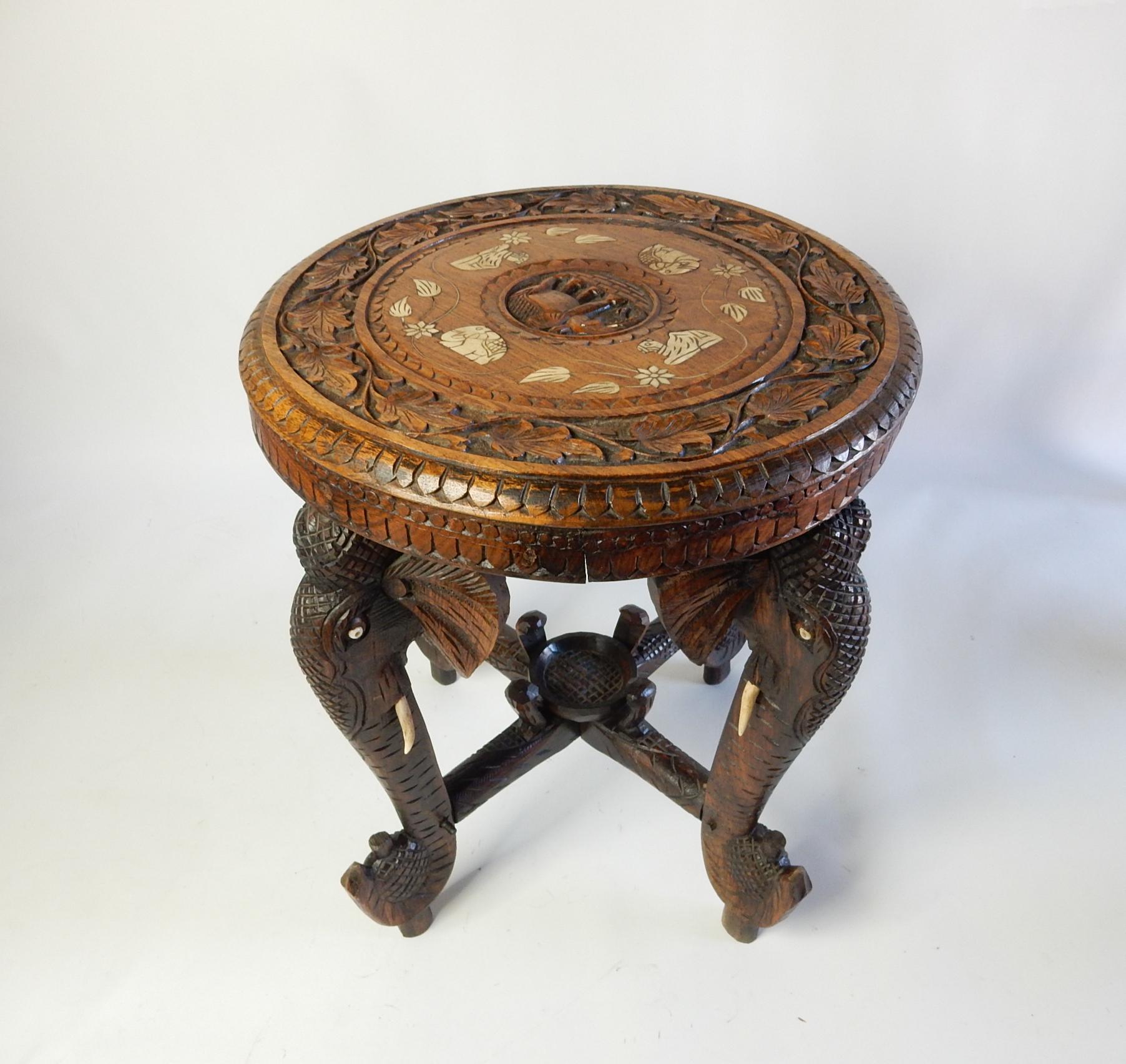 Antique 19th century Anglo-Indian Elephant leg side Gueridon/side table circa early 1900's. 
Heavily carved floral motif on top with bone inlay. Four carved elephant legs with hand carved bone tusks.
This table is in good solid antique condition