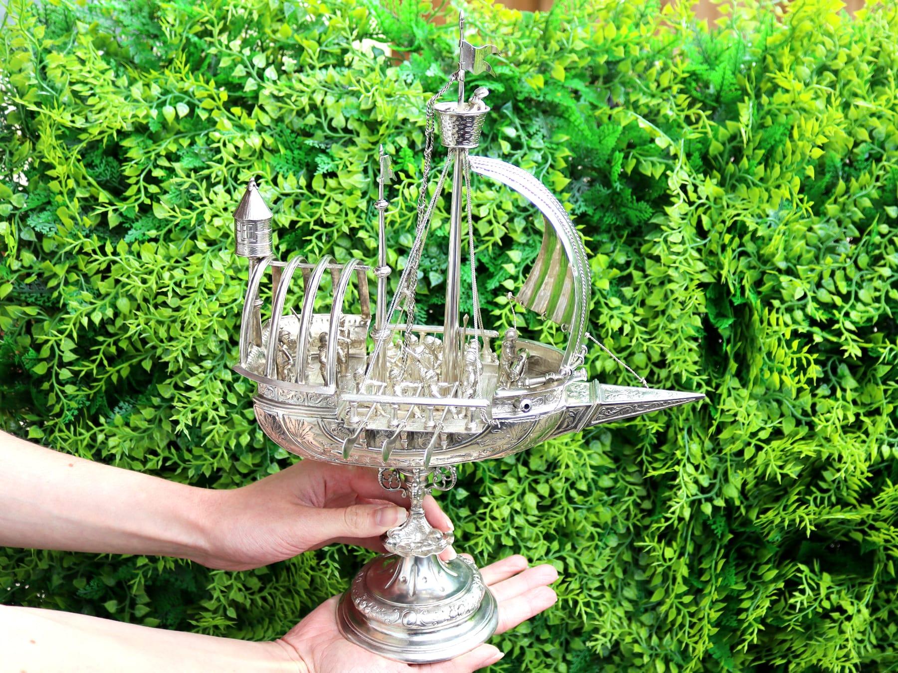 This exceptional, fine and impressive antique French silver nef* has been realistically modelled in the form of a ship.

The surface of the vessel is ornamented with impressive chased decoration paralleling the ship's form and depicting fish and