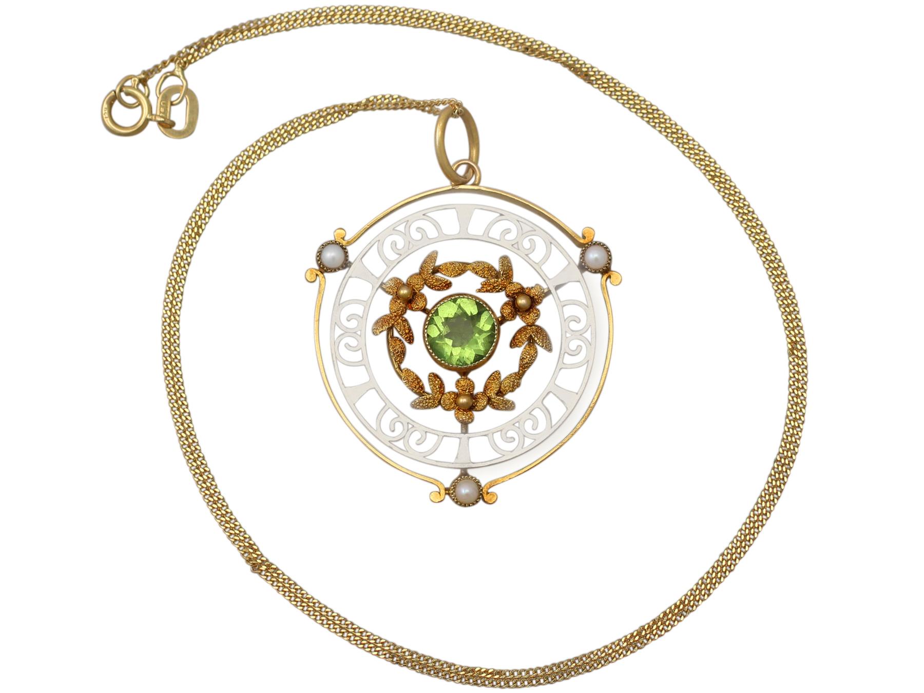 A fine and impressive antique 0.85 carat natural peridot and seed pearl, 15 karat yellow gold, 15 karat white gold pendant; part of our antique jewelry and estate jewelry collections.

This fine and impressive antique pendant has been crafted in 15k