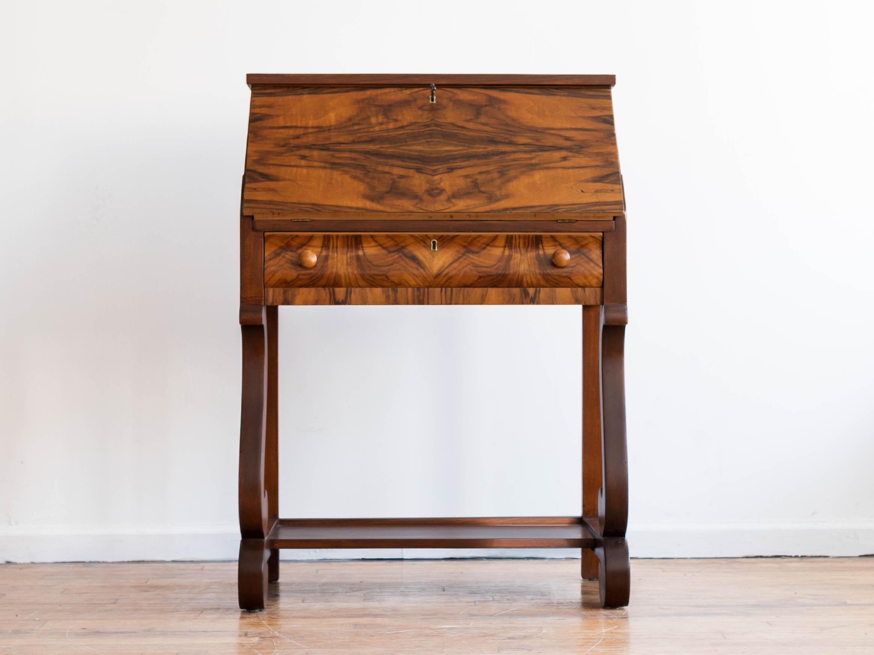 28” x 15.5” x 38.5”H; desk height 28”

Gorgeous Empire-style rosewood secretary desk from the turn of the century with Biedermeier influences. 

• four-way matched rosewood veneer 
• single center drawer
• built in cubbies with a second smaller