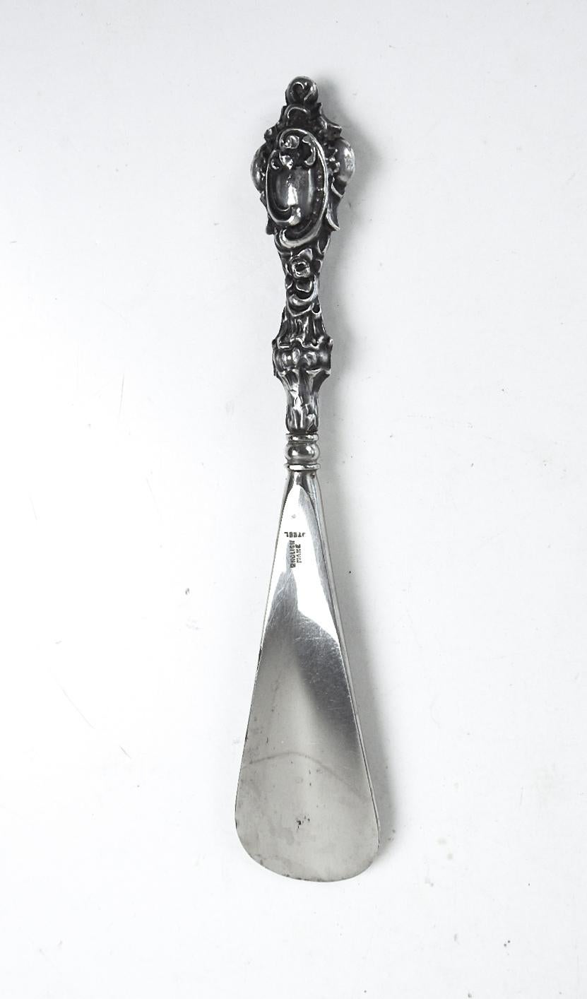 Antique 1904 British shoe horn.  Sterling silver Art Nouveau repousse handle with steel shank.  Marked ES Barnsley Company Birmingham England.  Overall patina, some edge nicks to steel shank.