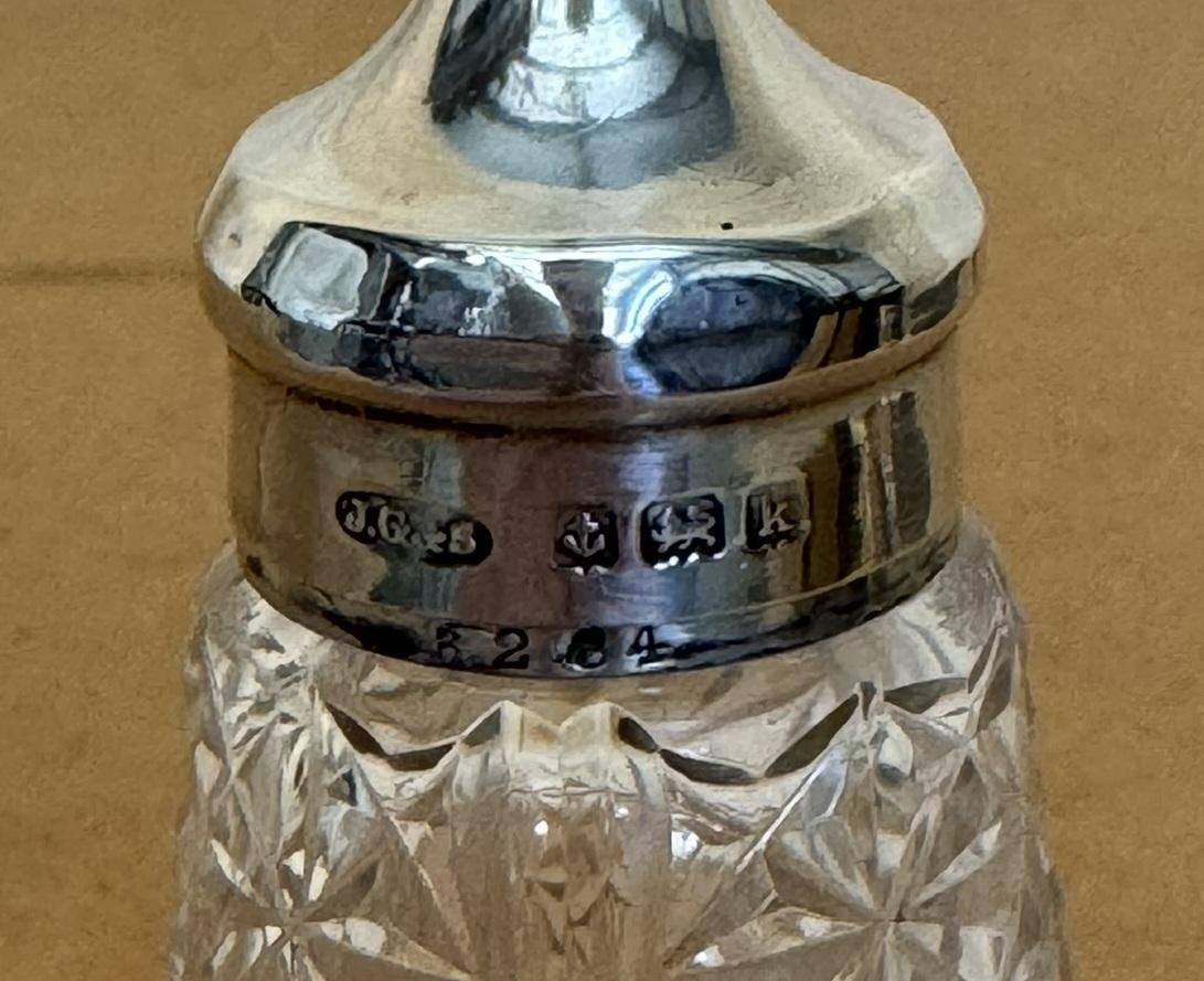 Royal House Antiques

Royal House Antiques is delighted to offer for sale this lovely Antique 1909 John Grinsell & Sons salt shaker with Sterling Silver top

A very good looking well made and decorative piece, the main body is cut glass and the top