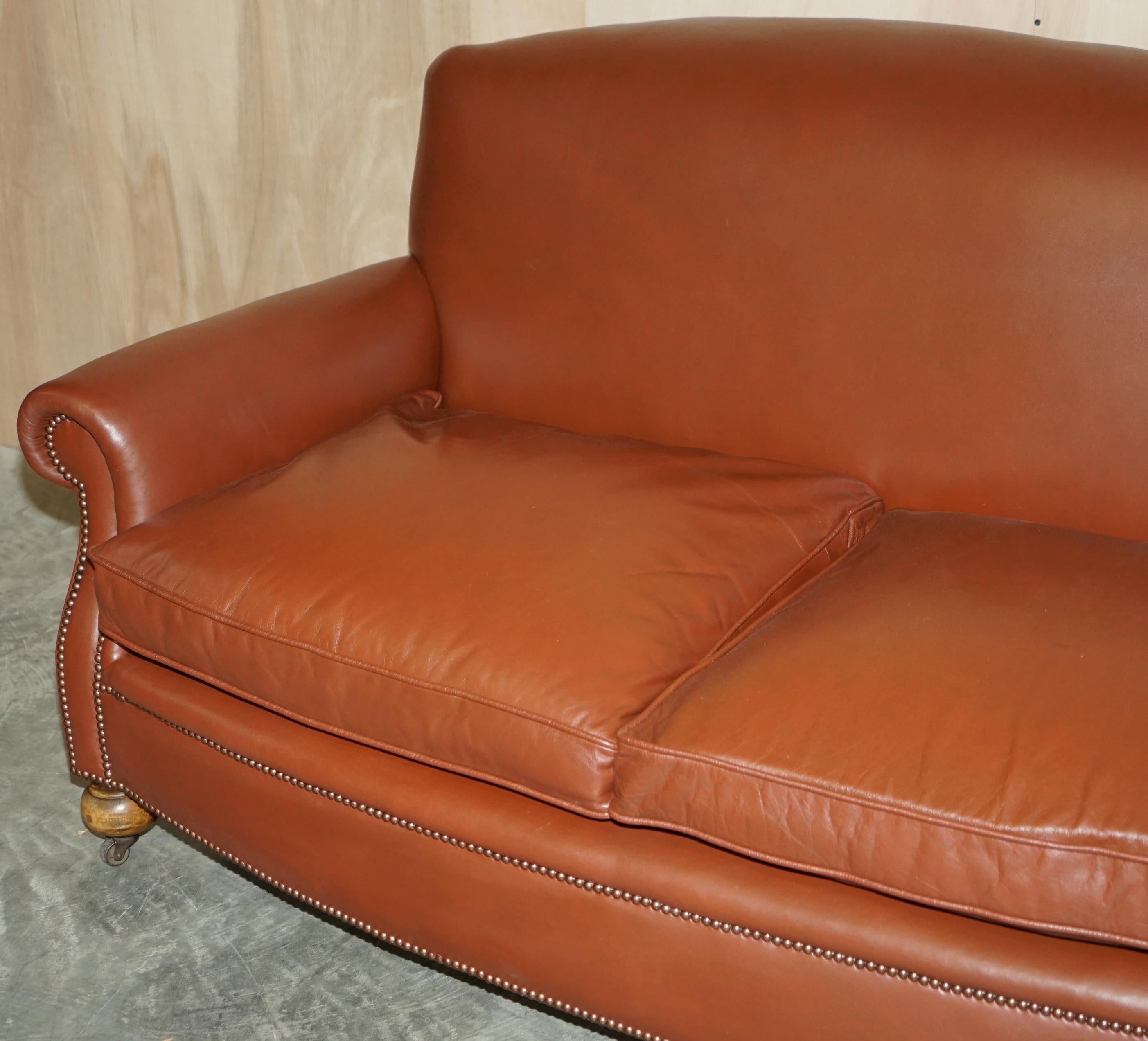 brown leather sofa with green cushions