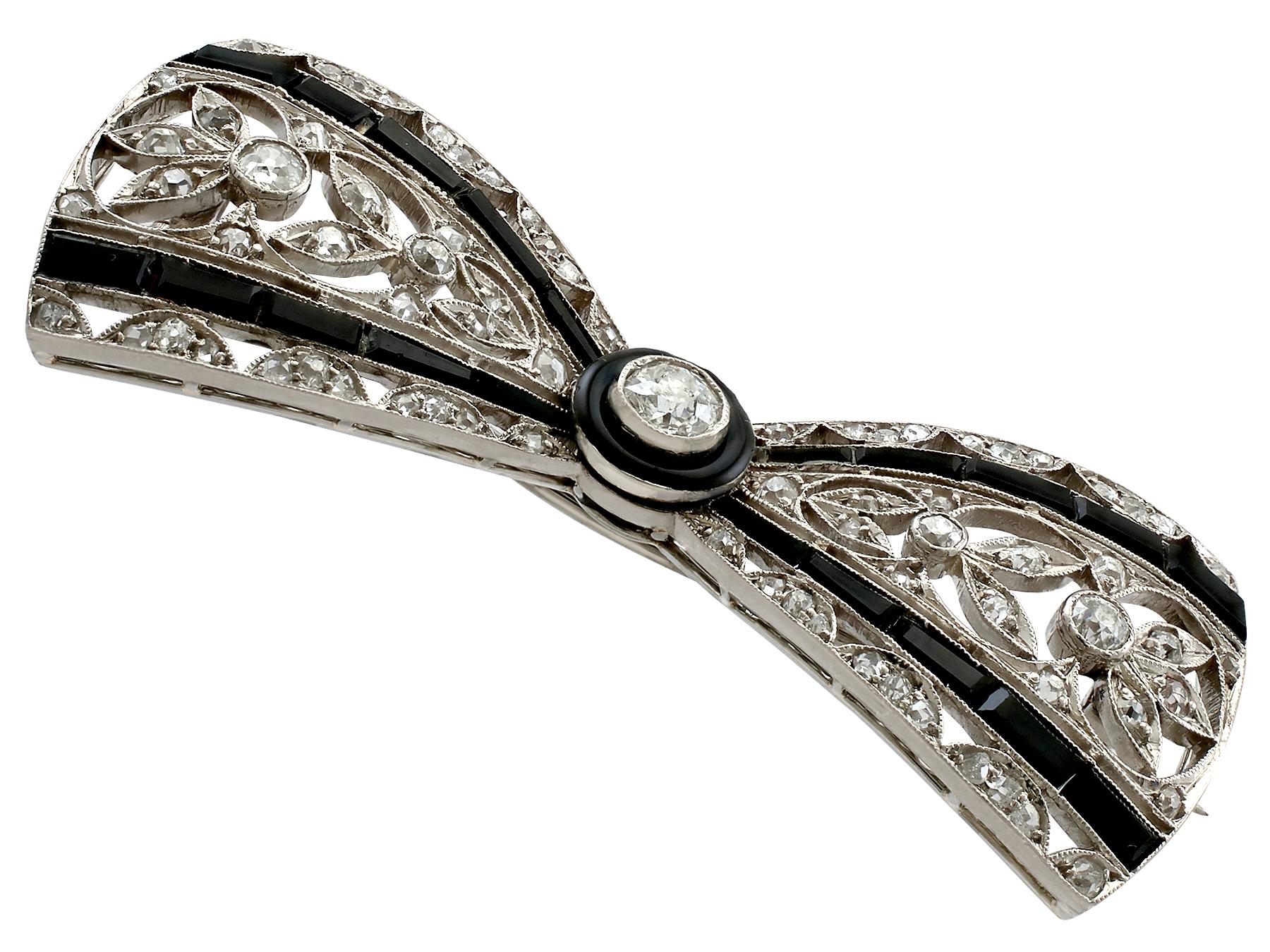 A stunning antique Art Deco 1.35 carat diamond and black onyx, platinum 'bow' brooch; part of our diverse antique jewelry and estate jewelry collections.

This stunning, fine and impressive Art Deco antique brooch has been crafted in platinum.

The