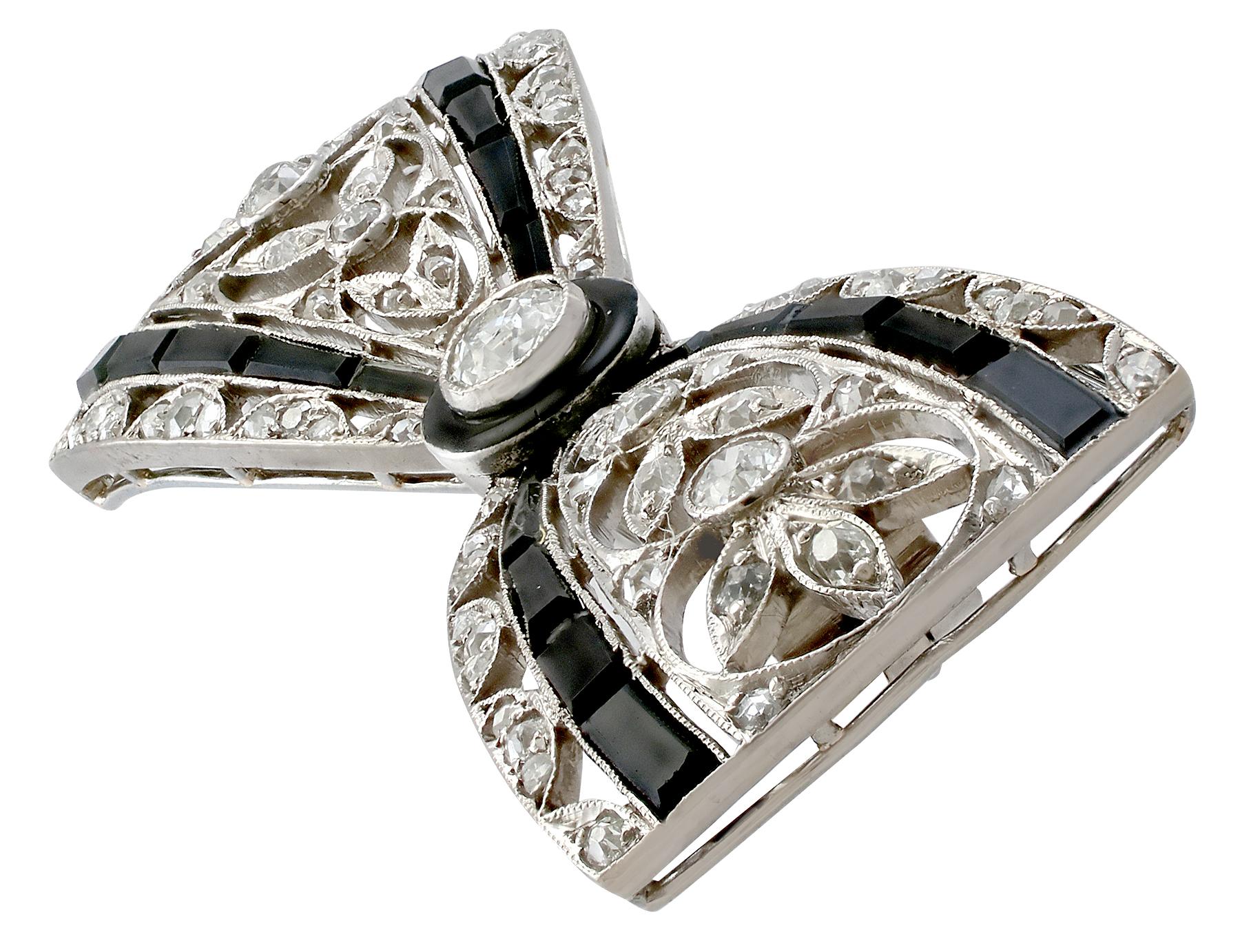Art Deco Antique 1910s 1.35 Carat Diamond and Black Onyx Platinum Bow Brooch
