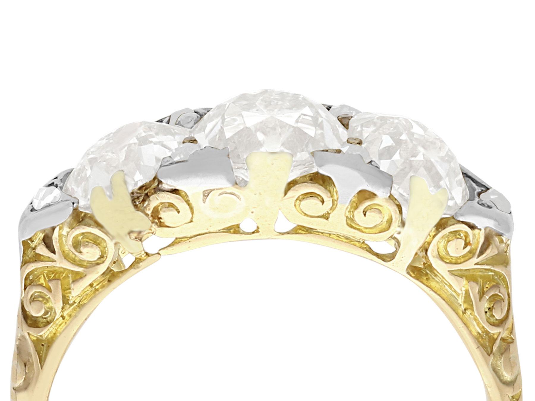 A stunning, fine and impressive antique 2.77 carat diamond and 18 karat yellow gold, platinum set trilogy ring; part of our diverse diamond jewelry and estate jewelry collections.

This fine and impressive diamond trilogy ring has been crafted in