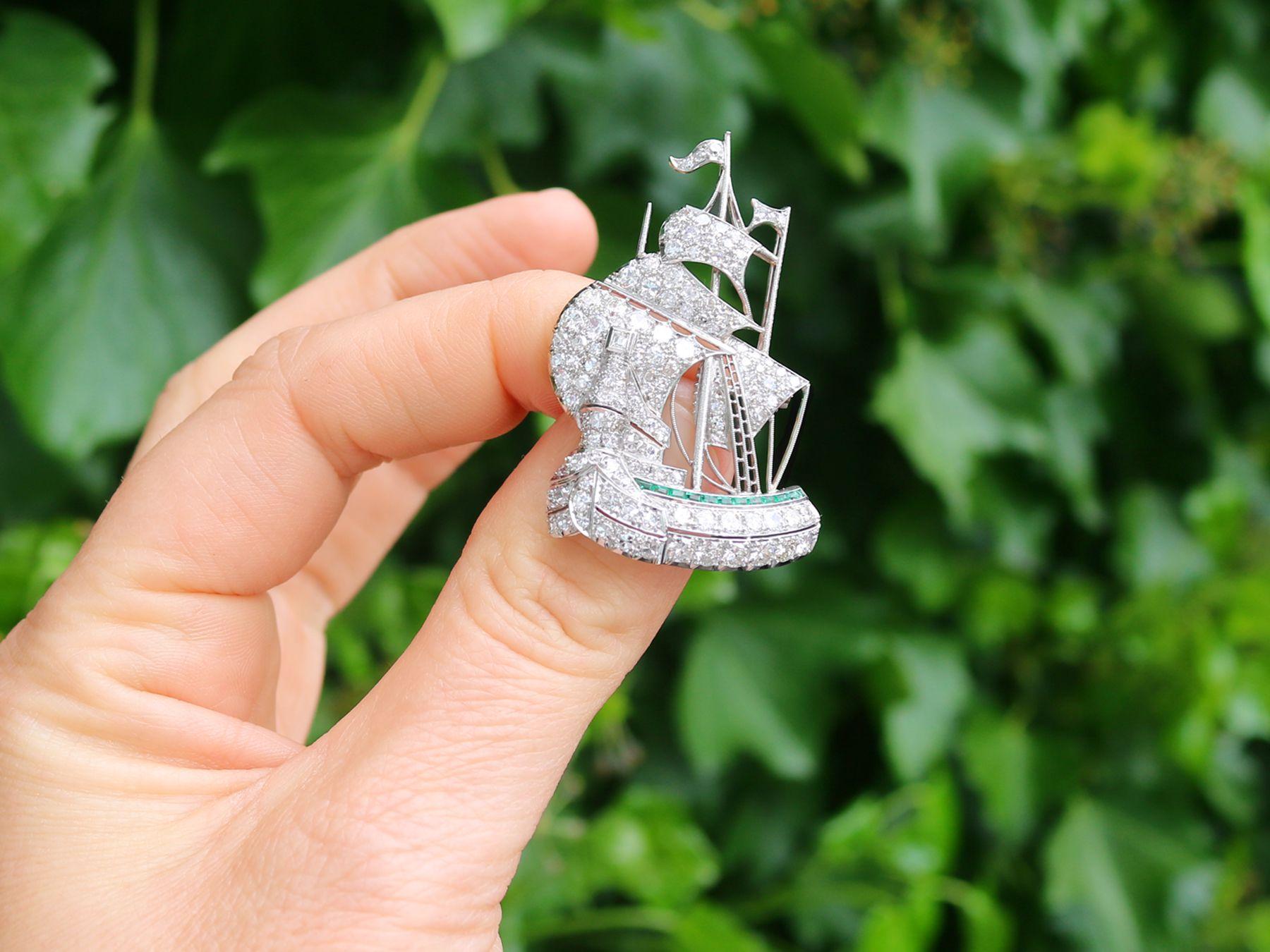 A magnificent and impressive antique 2.65 carat diamond and 0.28 carat natural emerald, platinum ship brooch; part of our diverse antique jewelry collections.

This magnificent, stunning, fine and impressive antique ship brooch has been crafted in