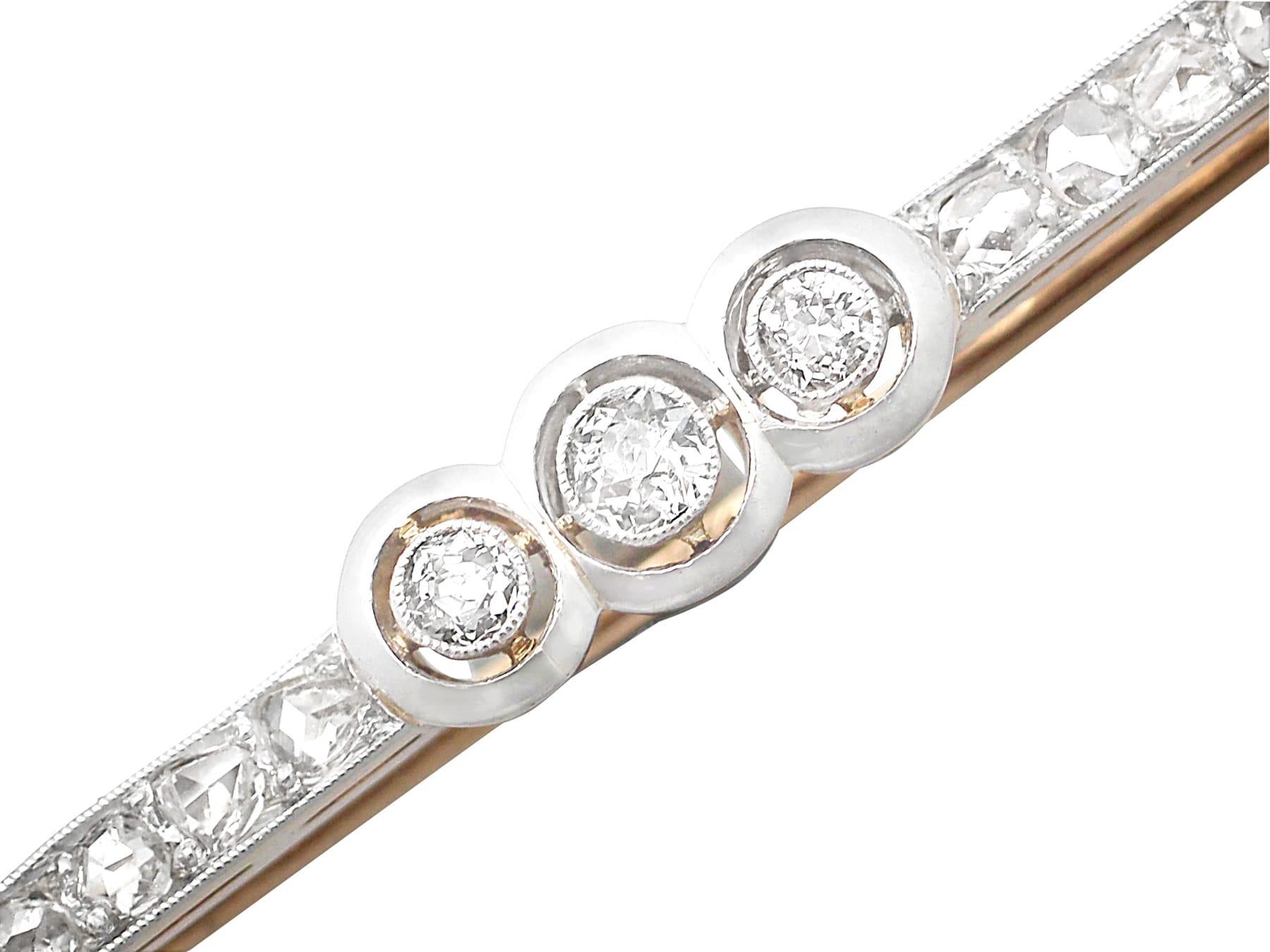 A fine and impressive 0.62 carat diamond and 15 karat yellow gold bar brooch with platinum setting; part of our antique jewelry and estate jewelry collections.

This fine antique diamond bar brooch has been crafted in 15k yellow gold with a platinum