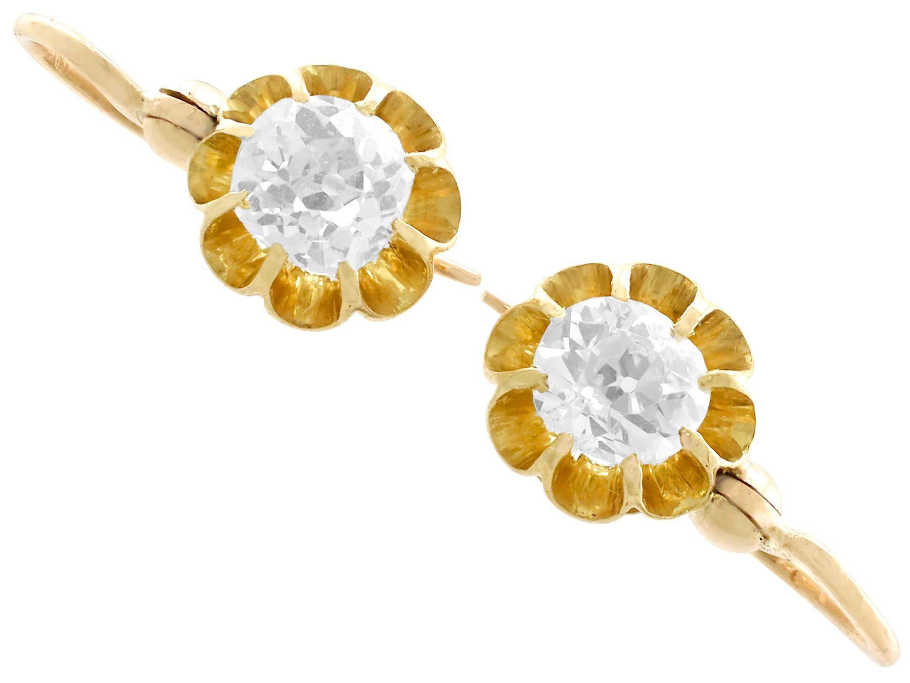A fine and impressive antique pair of 0.98 carat diamond and 15 karat yellow gold drop earrings; part of our diverse antique jewelry and estate jewelry collections.

These fine and impressive antique drop earrings have been crafted in 15k yellow