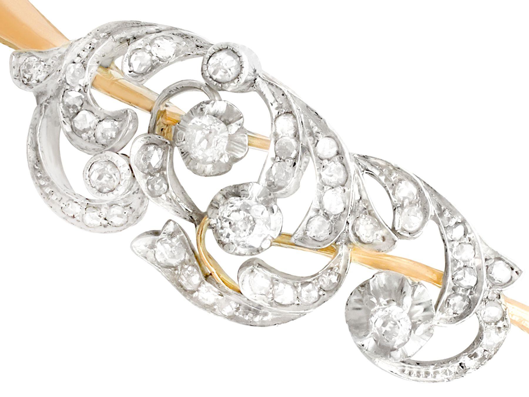 A stunning antique Russian 1.16 carat diamond and 14k yellow gold, 14k white gold set bangle; part of our diverse antique jewelry collections.

This stunning, fine and impressive diamond bangle has been crafted in 14k yellow gold with a 14k white