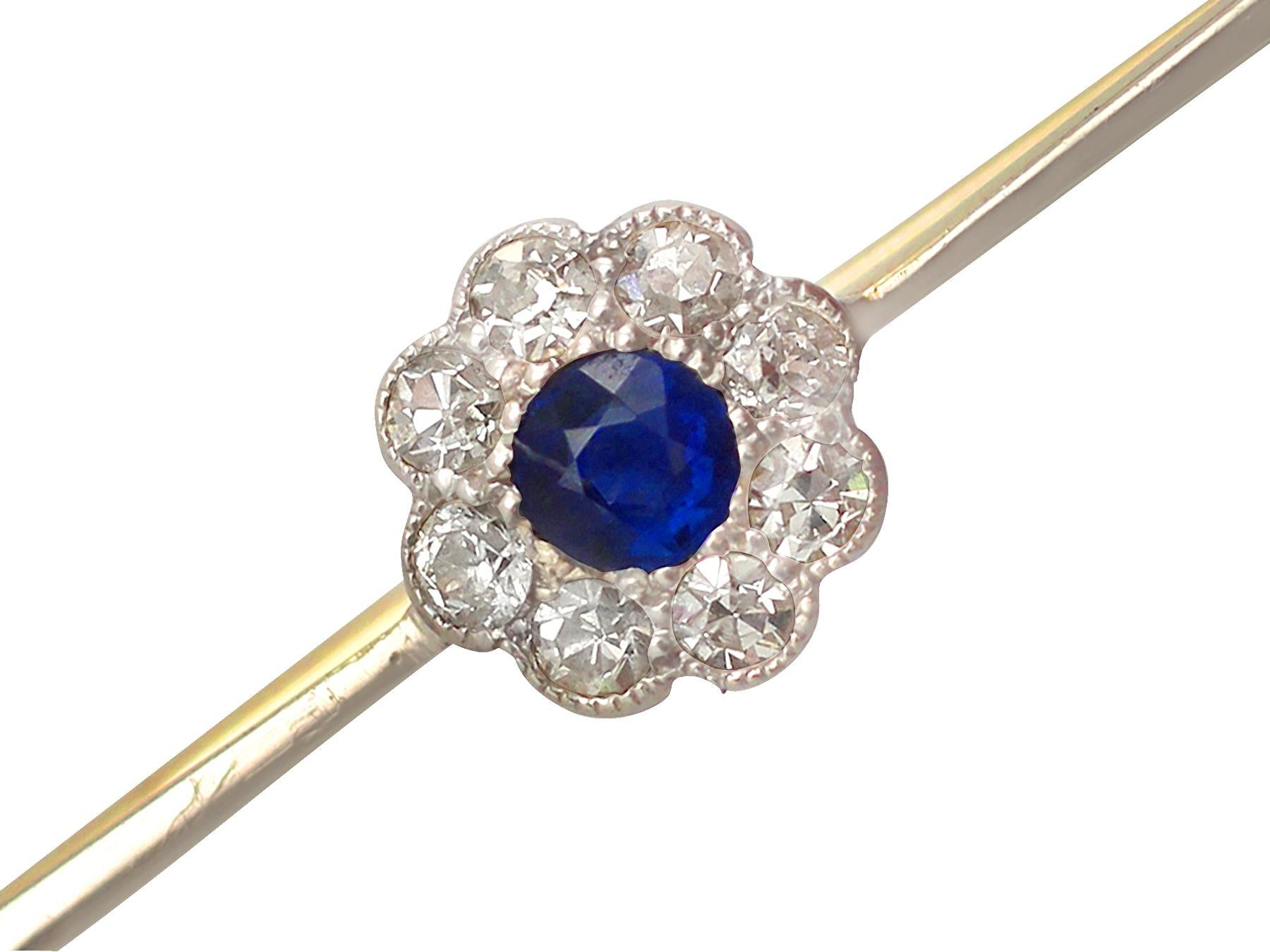A fine and impressive 0.16 carat natural blue sapphire and 0.26 carat diamond cluster set, 15 karat yellow gold, platinum set bar brooch; part of our diverse antique jewelry and estate jewelry collections.

This fine and impressive sapphire and