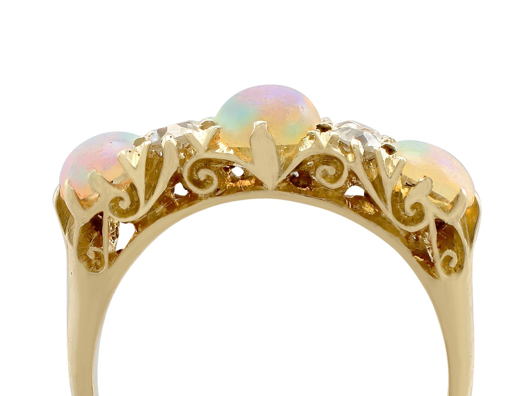 An impressive antique 1.74 carat opal and 0.40 carat diamond, 18 karat yellow gold dress ring; part of our diverse antique jewelry and estate jewelry collections.

This fine and impressive opal and diamond ring has been crafted in 18k yellow