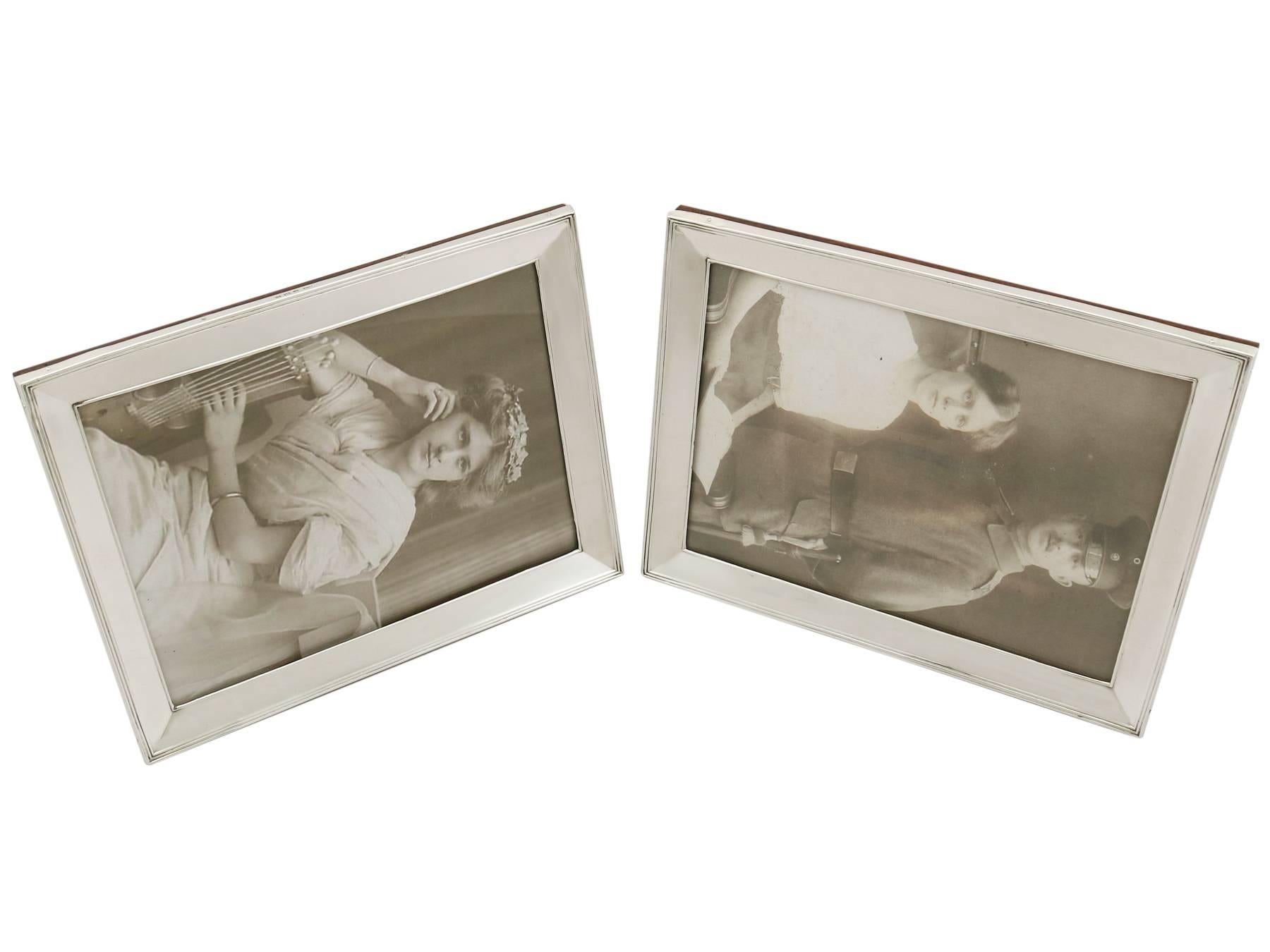 A fine and impressive pair of antique George V English sterling silver photograph frames; an addition to our ornamental silverware collection.

These fine antique George V English sterling silver photograph frames have a plain rectangular form.

The