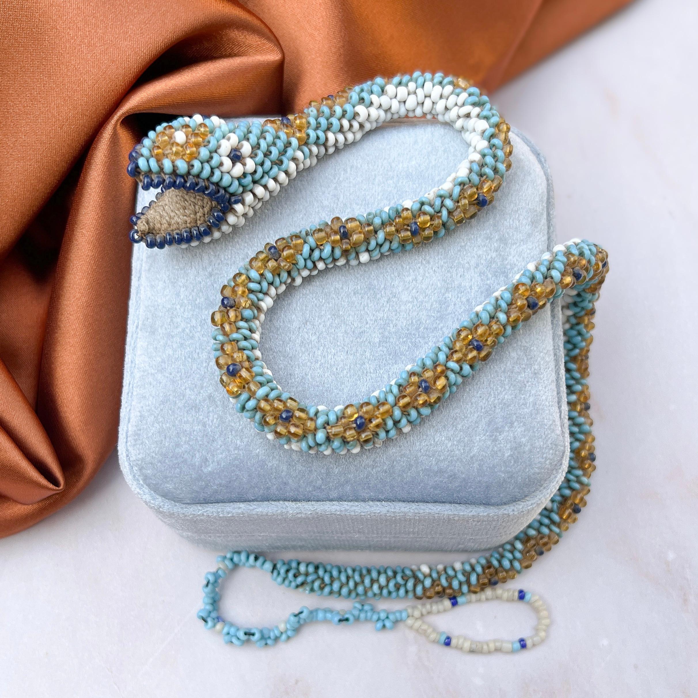 Remarkable and rare, this beaded snake necklace was handcrafted by Turkish prisoners of war between 1914-1918.

Condition Report:
Excellent - The bead strand and loop at the end of the tail have been added to the piece by a professional beadwork