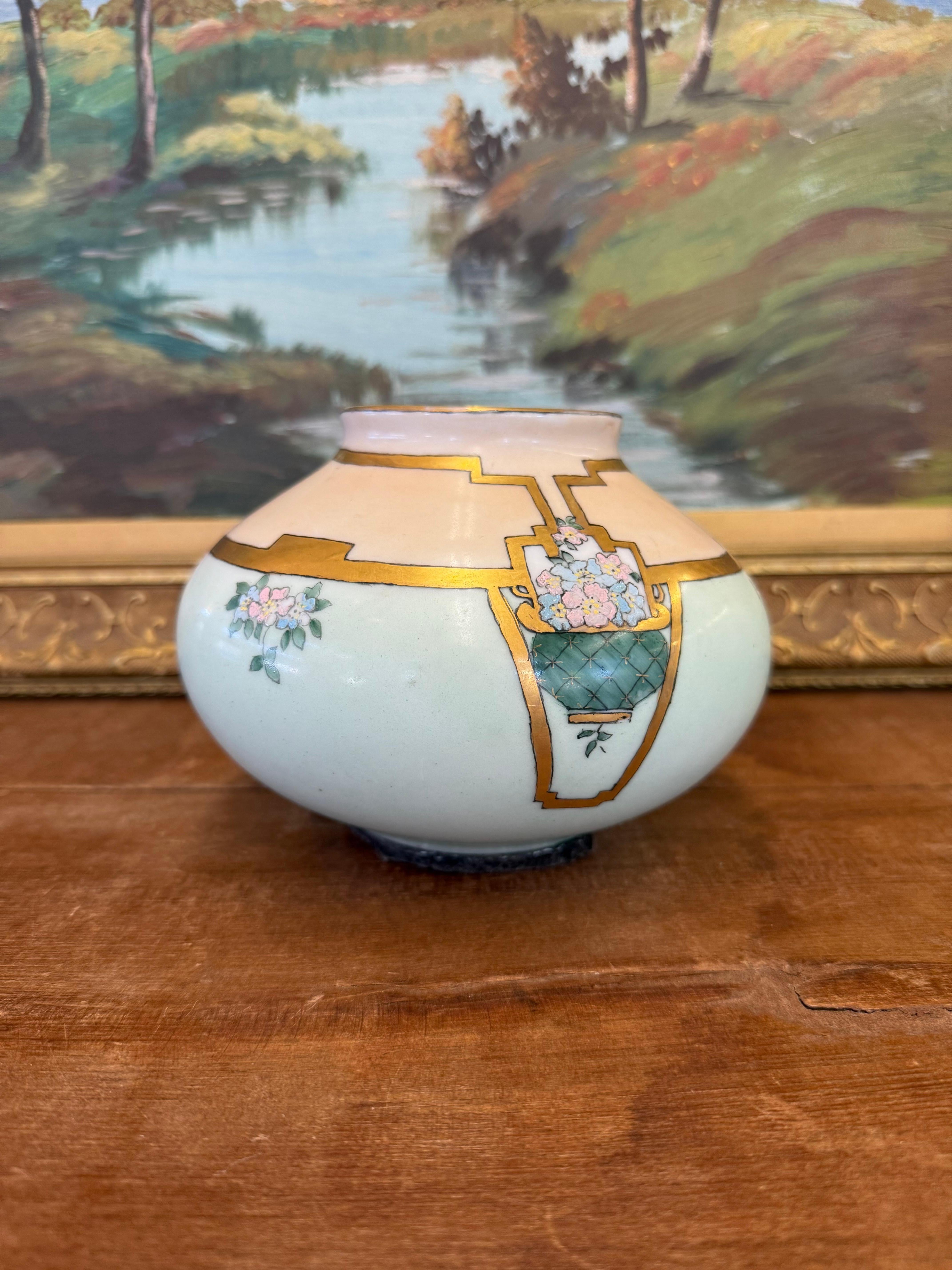 Hand-painted porcelain vase marked Imperial PSLAustria and signed by the artist, likely dated 1918. The body features a matte celadon glaze with hand-detailed florals and basket motifs outlined in worn gilt.

The gold tone detailing shows