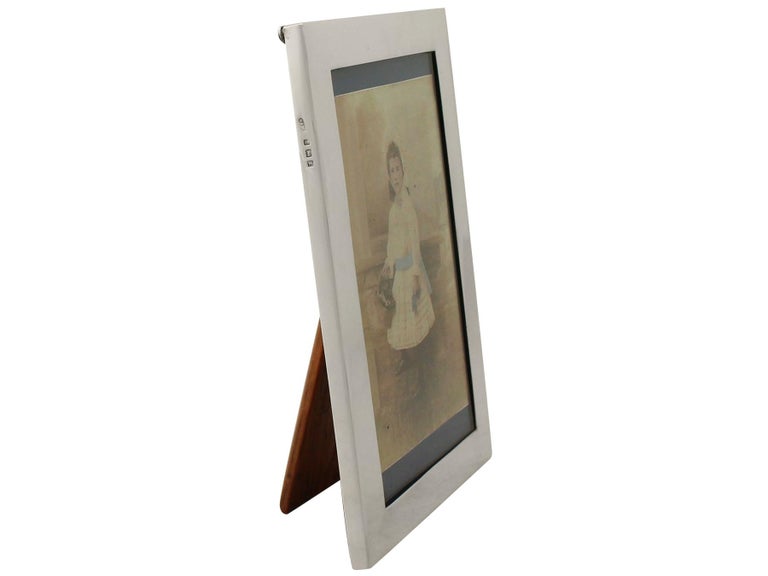 A fine and impressive antique George V English sterling silver photograph frame an addition to our collection of ornamental silverware.

This fine antique George V sterling silver photo frame has a plain rectangular form.

The surface of this