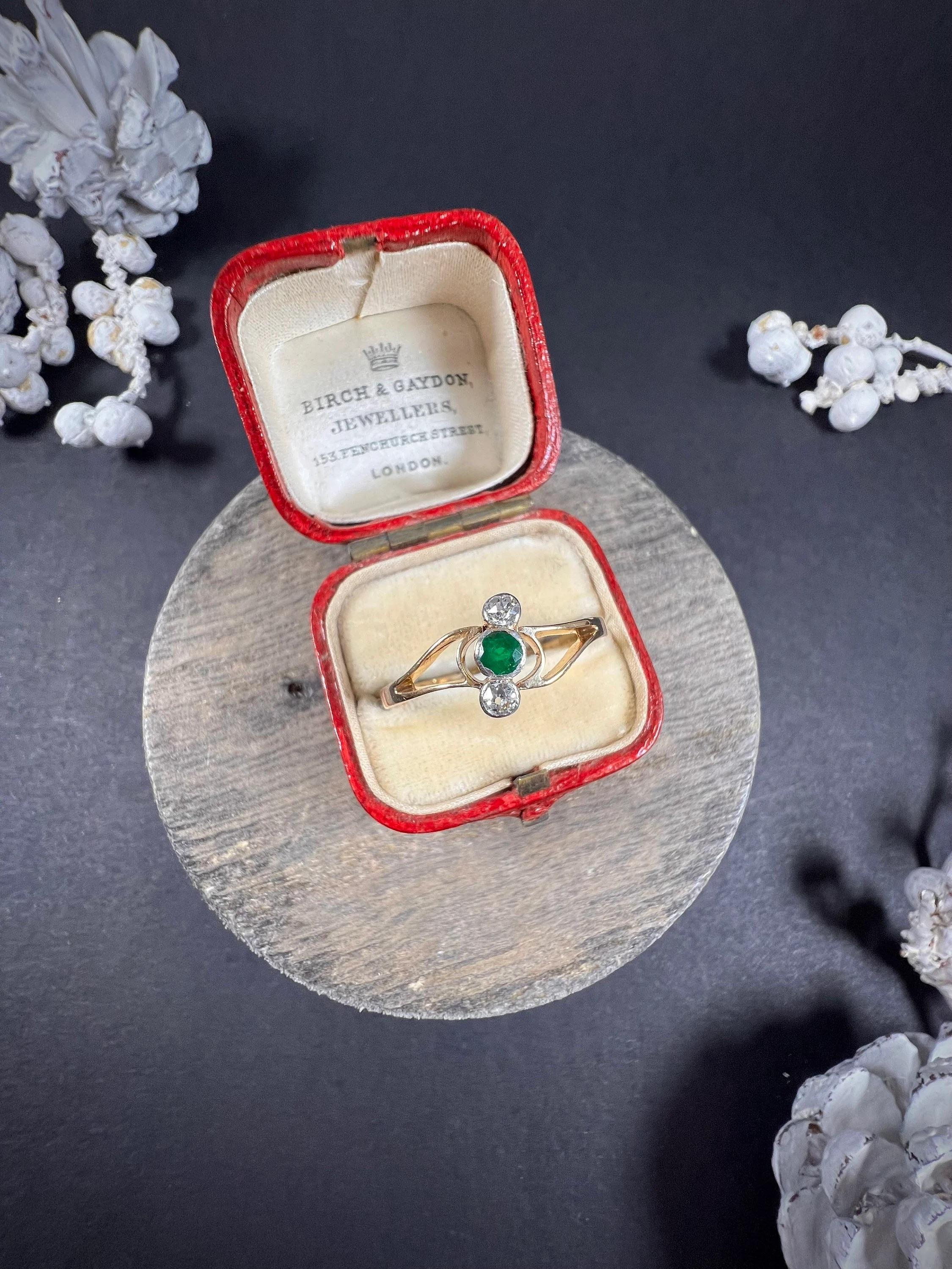 Antique Emerald & Diamond Crossover Ring

18ct Gold & Platinum Stamped 

Circa 1920s

This exquisite 18ct gold stamped ring is a stunning representation of the 1920s era. Featuring a beautiful emerald and diamond three-stone design, the stones are