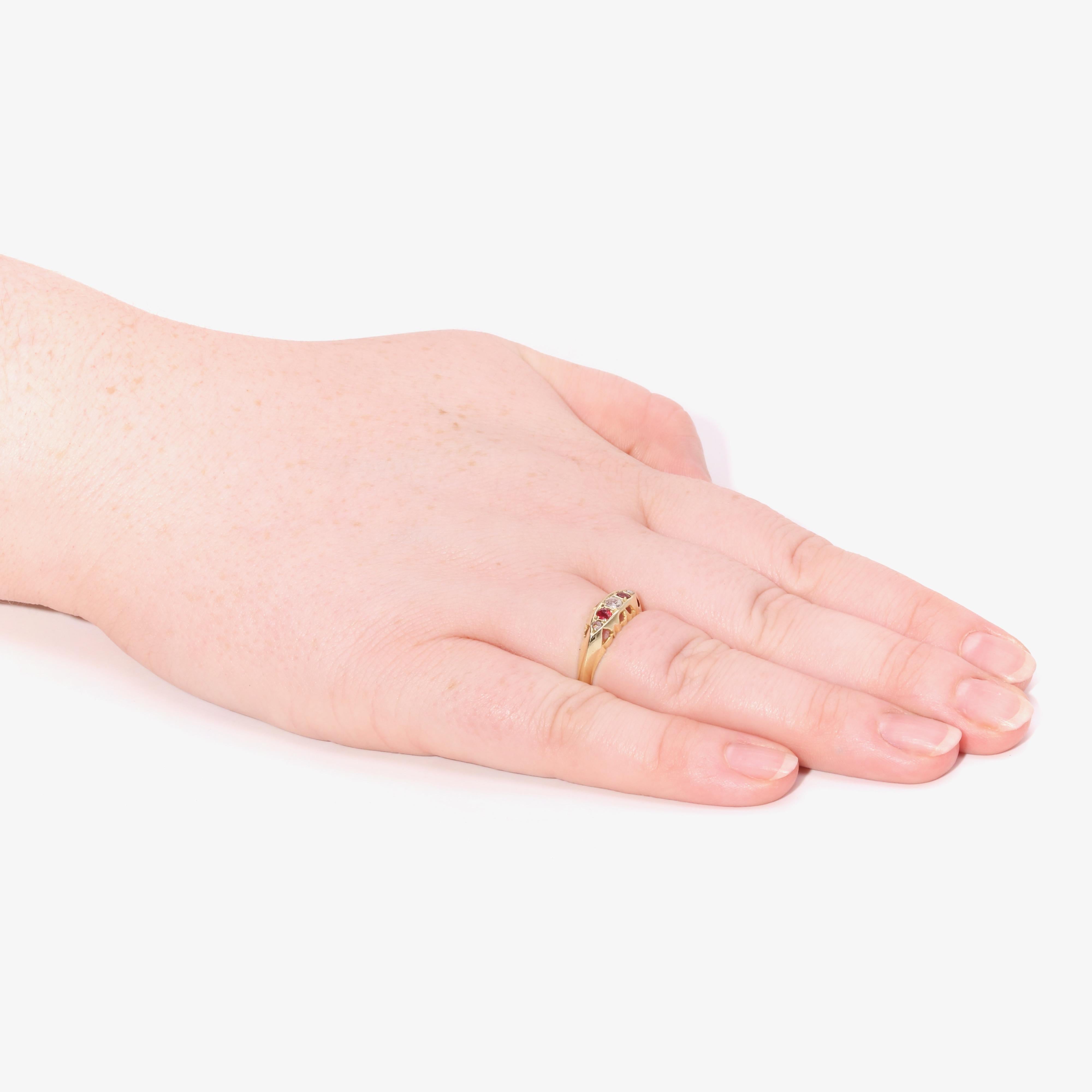 An antique diamond, ruby, and yellow gold ring, comprising one old European cut diamond, two rose cut diamonds, and two round cut rubies, set in 18 karat yellow gold, to an 18 karat yellow gold band. 

This antique ring is set to the centre with an
