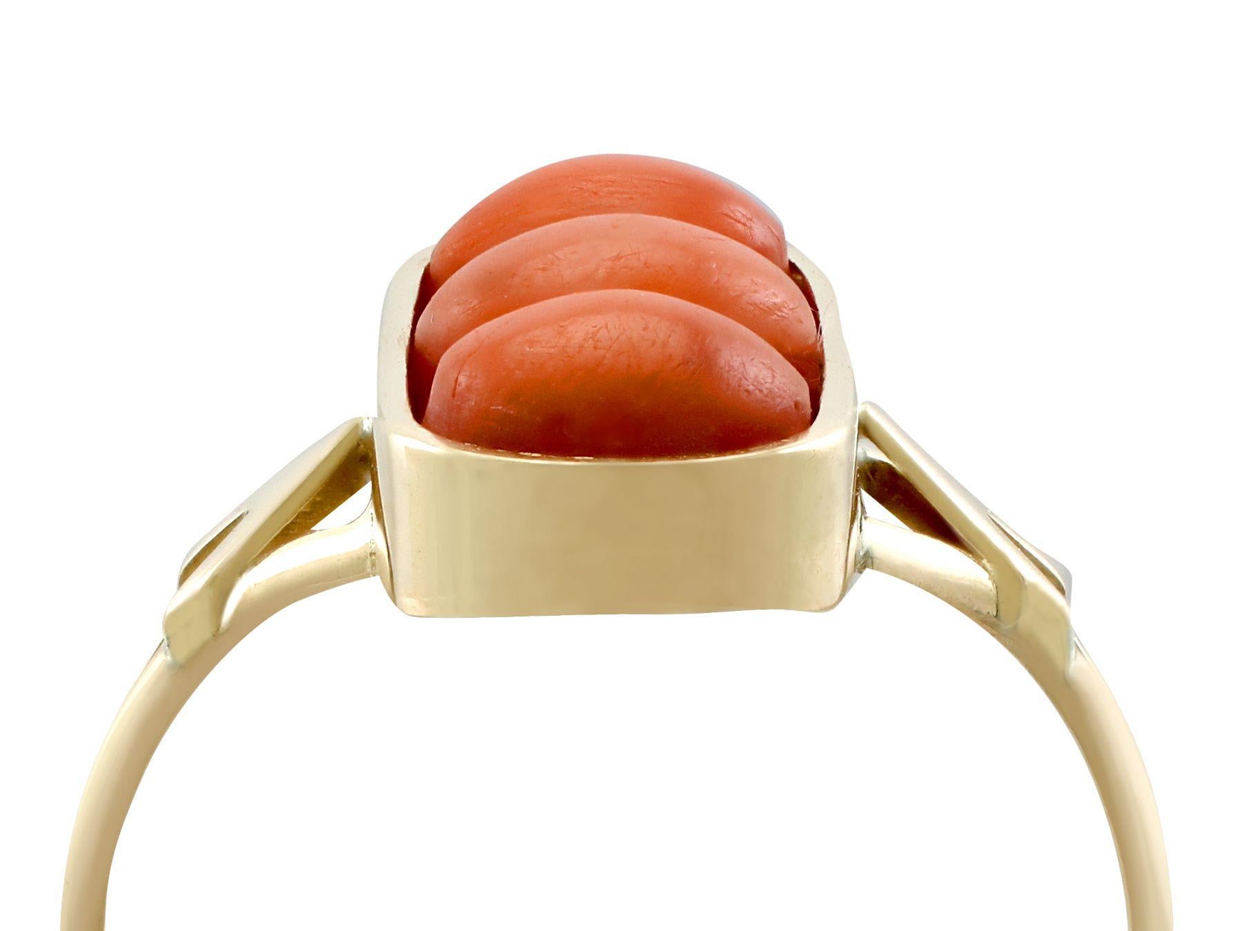 An impressive antique 1920s 3.60 carat coral and 14 karat yellow gold dress ring; part of our diverse antique jewelry and estate jewelry collections.

This fine and impressive gemstone ring has been crafted in 14k yellow gold.

The oval shaped frame