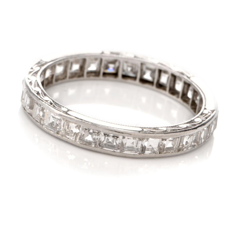 This chic and tastefull 1920's antique diamond eternity ring is crafted in solid platinum, weighing 1.8 grams and measuring 3mm high. Showcasing a stunning arrangement of channel set, antique square cut diamonds,  collectively weighing
