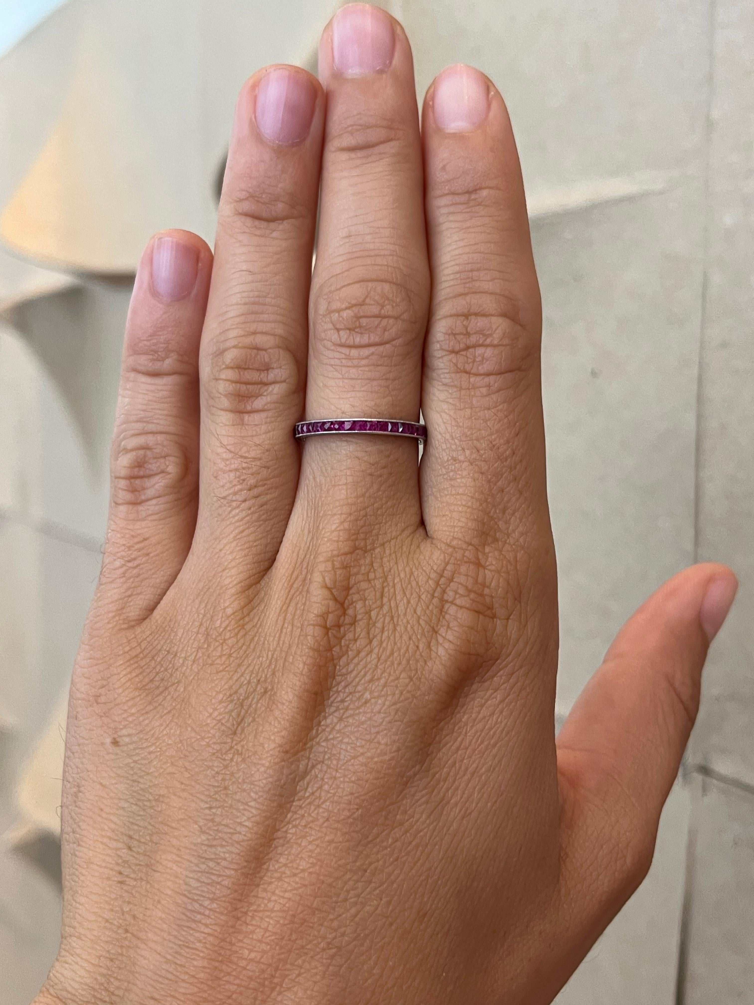 From the Bracken Jewelers antique fine jewelry collection in Santa Monica, California. This antique 1920s Burmese ruby eternity ring is a beautiful piece of history. 38 French cut rubies are channel set in the platinum band which features milgrain