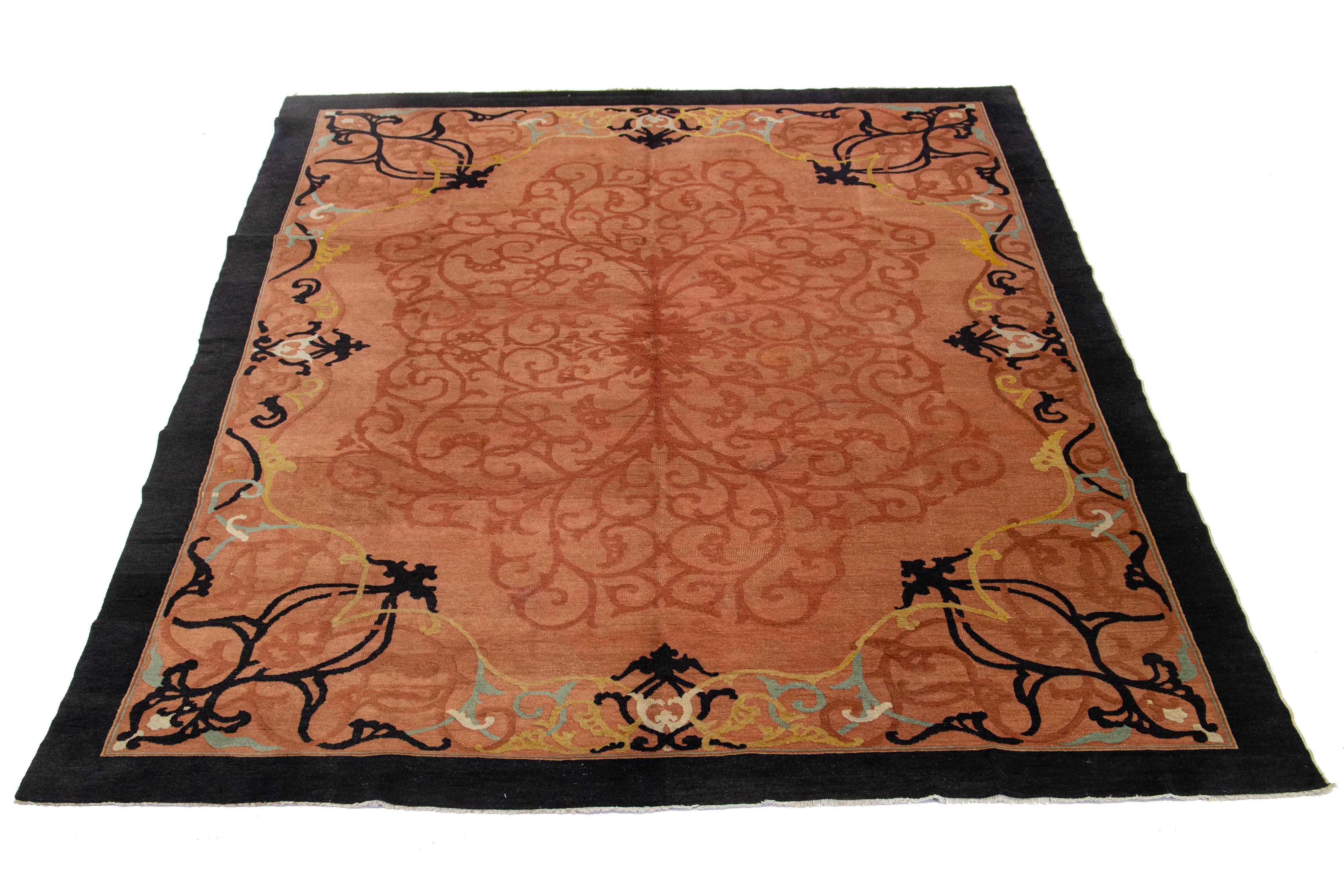 Beautiful 1920s antique Chinese Art Deco hand-knotted wool rug with terracotta color field. This piece has a designed frame in black hues adorned with a classic Chinese floral scroll design.


This rug measures 9' x 12'.
 