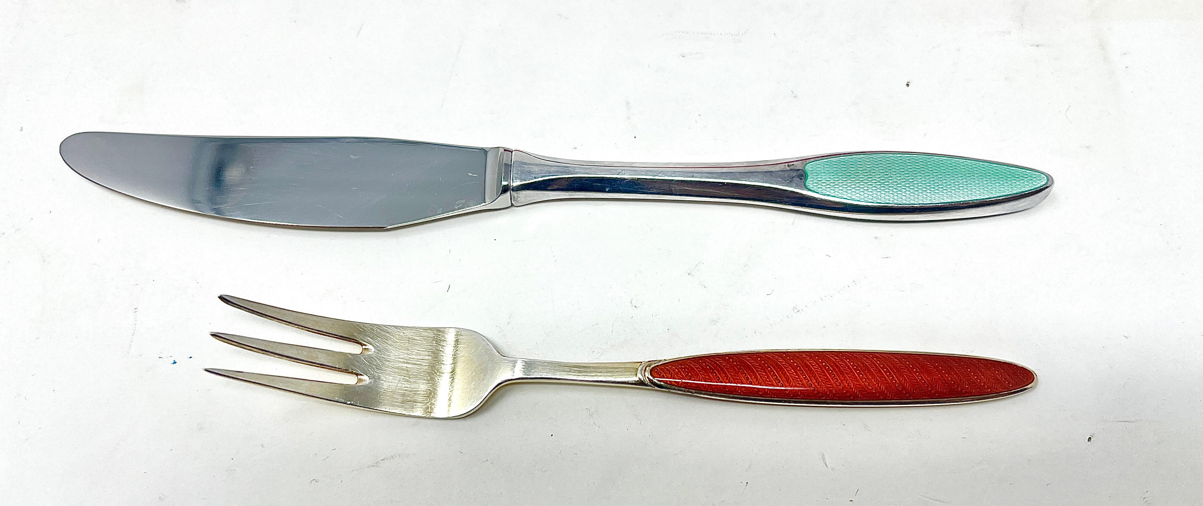 Antique Danish Sterling Silver and Multi-Colored Enamel 12 Piece Luncheon Set in Original Box, Circa 1920.
6 Forks and 6 Knives all in varying colors of blue, green, red, white, purple, yellow etc.
Knife = 7.25