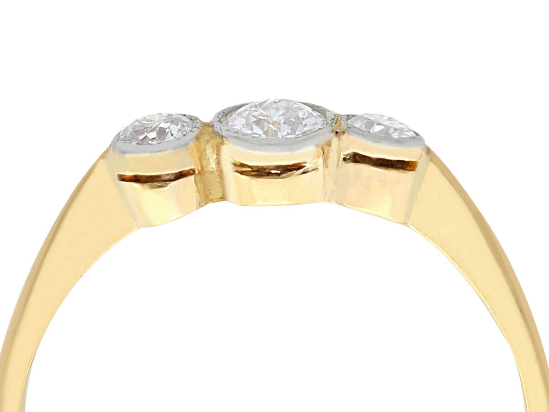 A fine and impressive antique 0.45 carat diamond (total) and 18 karat yellow gold, 18 karat white gold set three stone / trilogy ring; part of our diverse diamond jewelry and estate jewelry collections.

This fine and impressive trilogy ring has