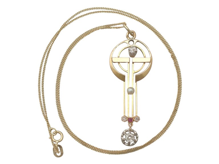 An impressive German 0.60 Carat diamond and seed pearl, ruby and 18 karat yellow gold, 18 karat white gold set pendant; part of our diverse Art Nouveau jewelry collections.

This fine and impressive Art Nouveau pendant has been crafted in 18k yellow