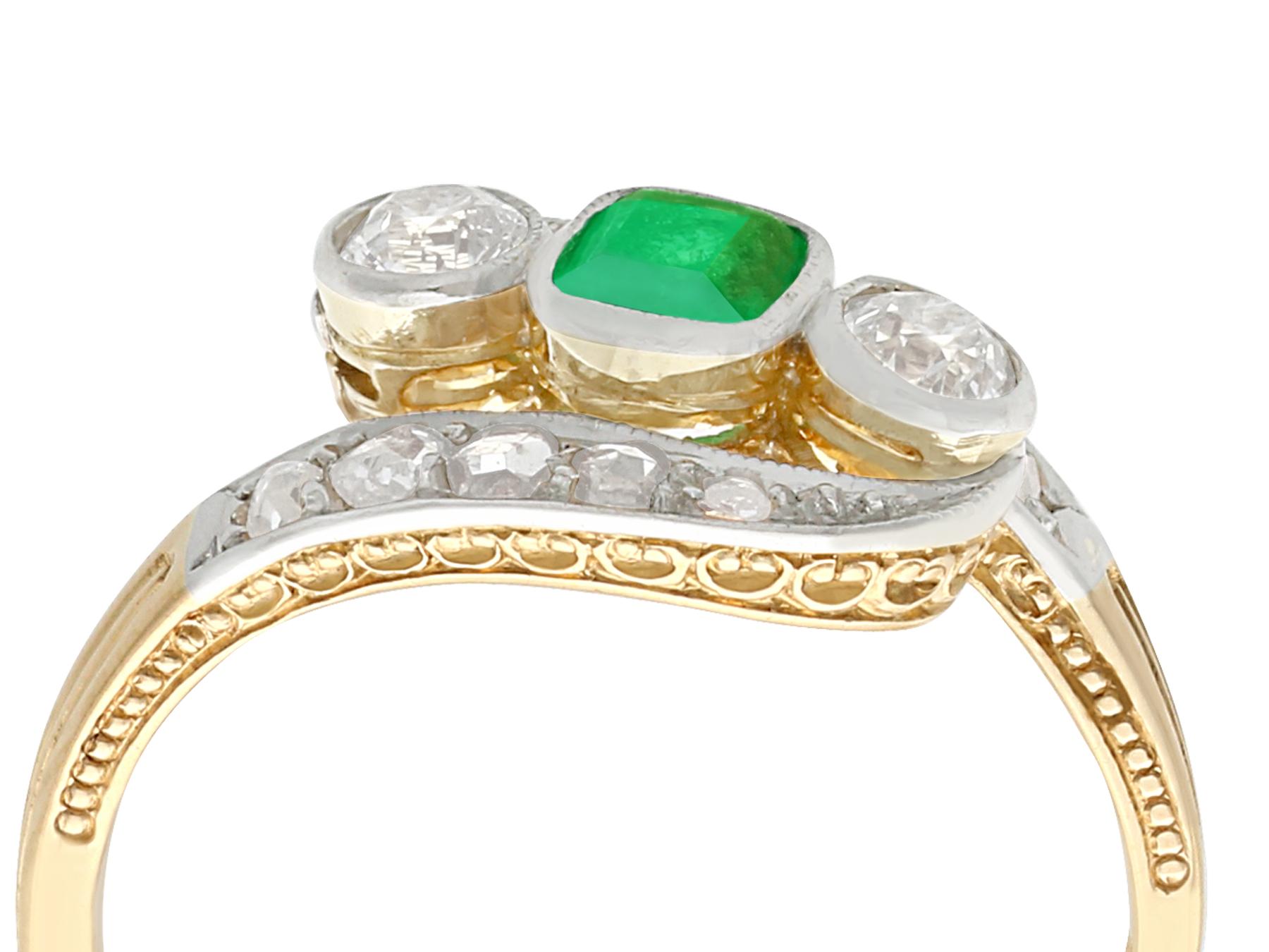 A fine antique 0.23 carat emerald and 0.35 carat diamond, 14 karat yellow gold and platinum twist ring; part of our diverse antique jewelry collections.

This fine and impressive antique emerald and diamond twist ring has been crafted in 14k yellow