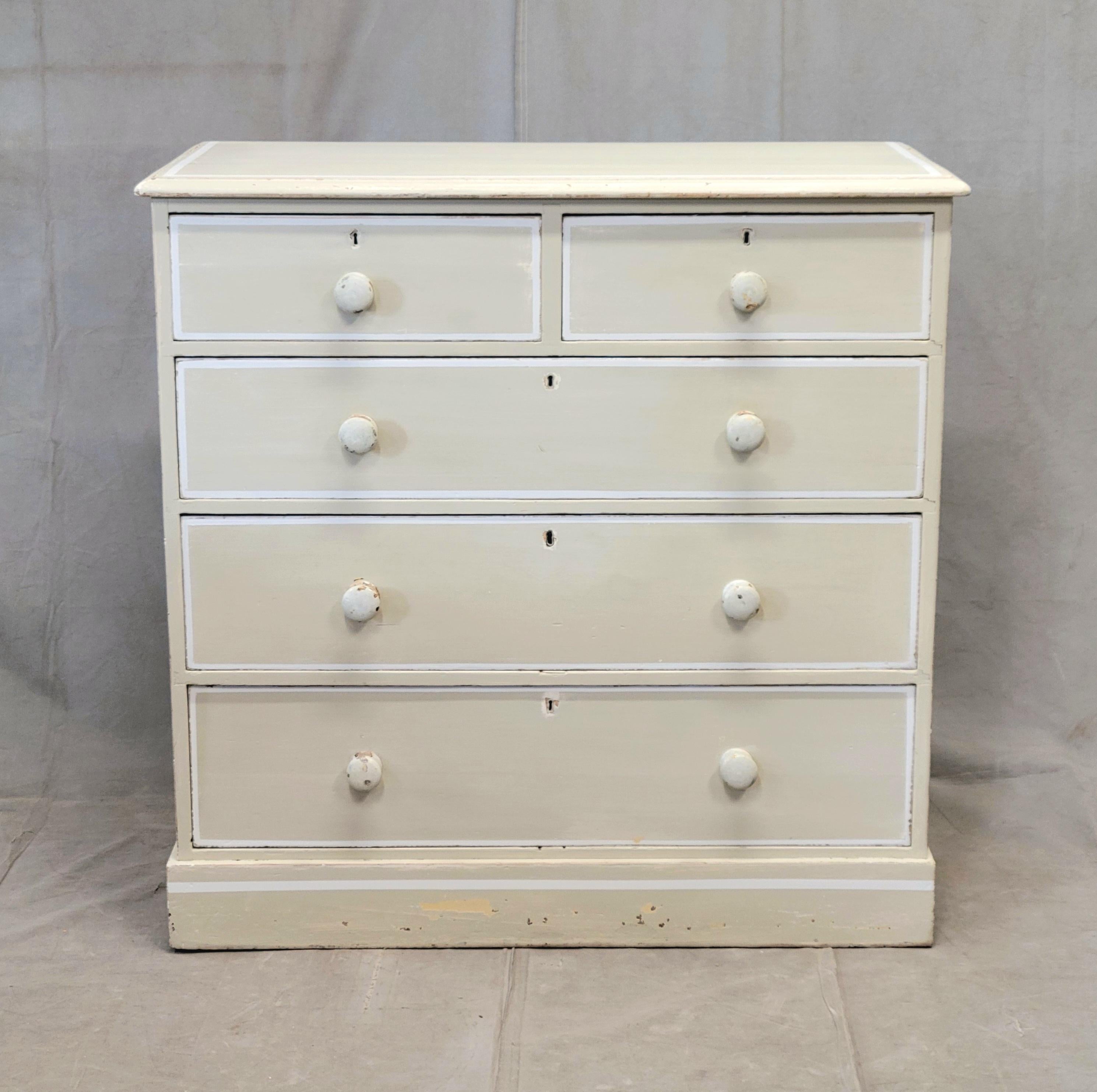 A classic antique circa 1920s English pine dresser with old cream colored paint accented with a white French line. The color combination is so understated and elegant, which would blend with almost any color scheme. The surface of the paint is