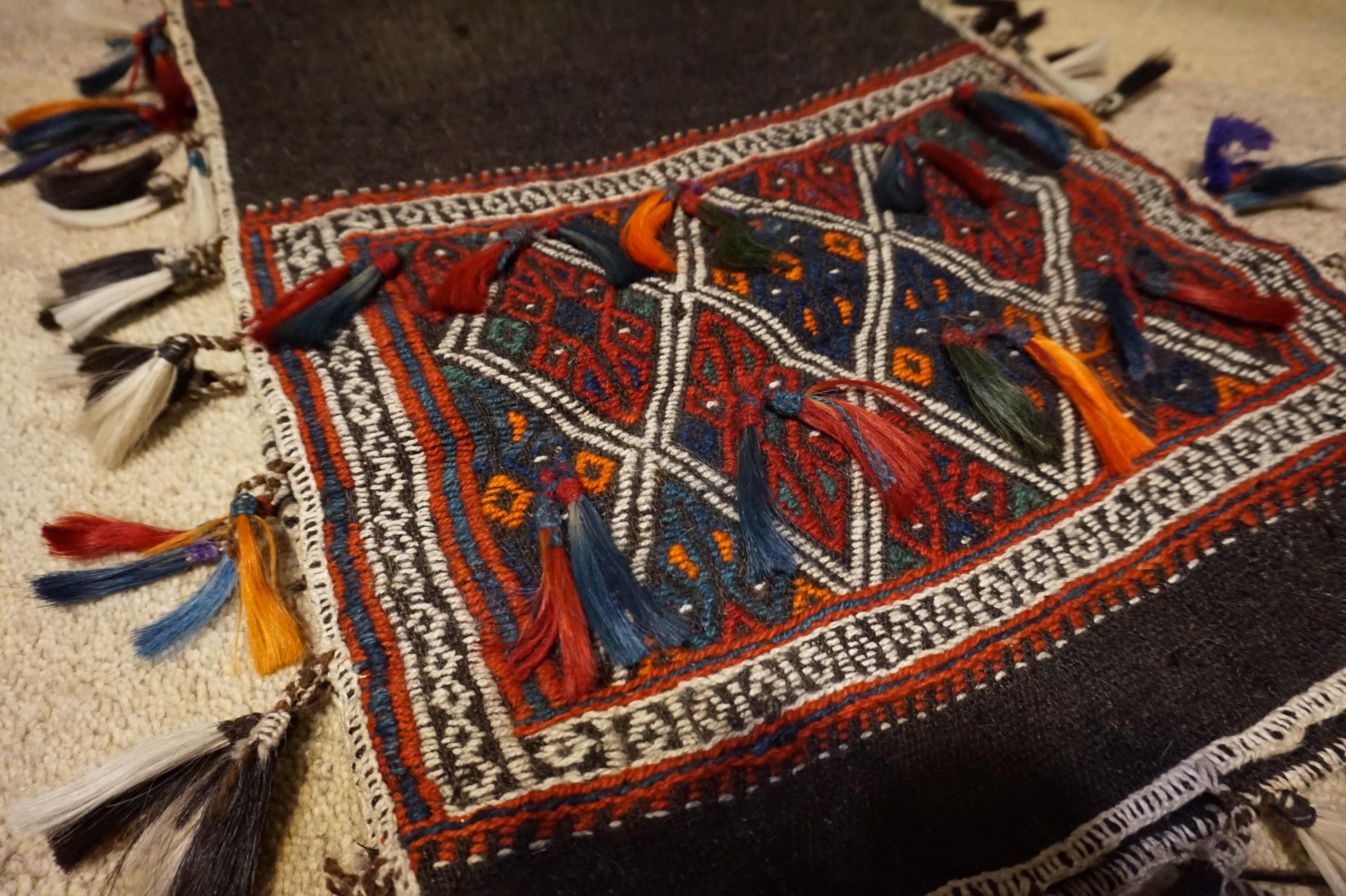 Fine example of older Turkish saddle bag with 1926 export seal. Lovely colorful kite shape pattern juxtaposed against a dark brown near black background. In good condition,

circa 1920s.