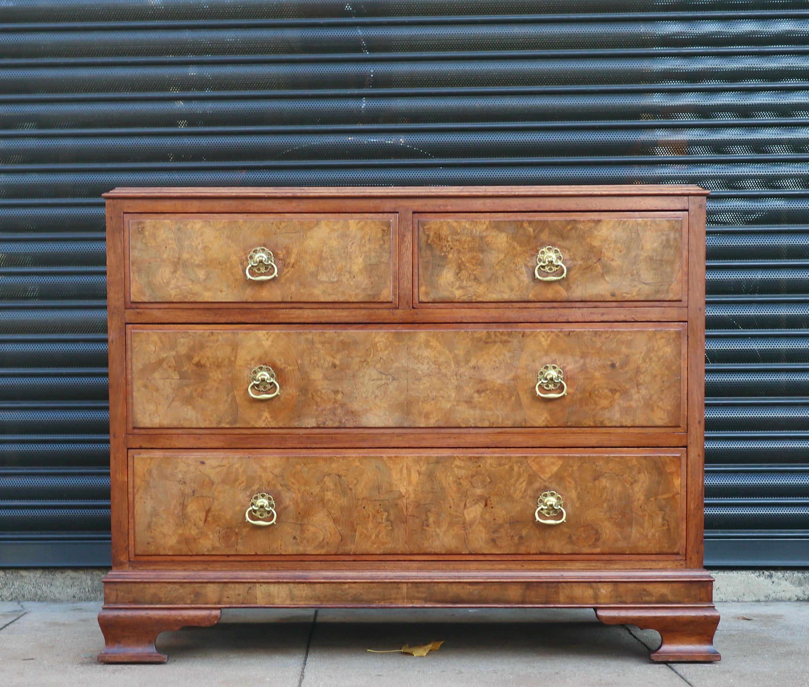A stylish and beautiful English 1920s four drawer chest of drawers with a solid mahogany carcass, burr walnut fronts and metal handles.
Antique Queen Anne Revival Burr Walnut Chest Of Drawers Signed And Dated 1926.
The top has some minor water