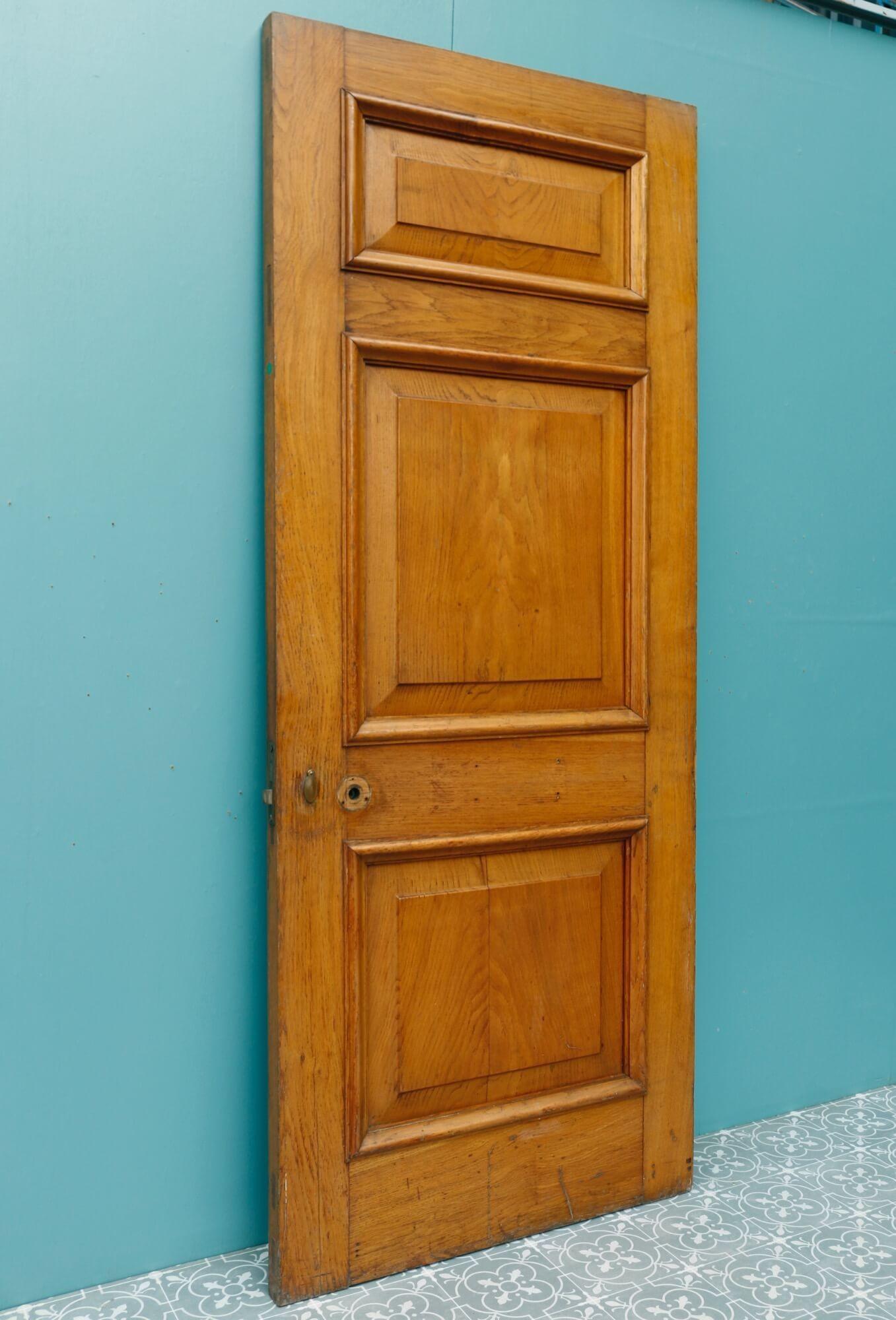 A strong and substantial reclaimed antique 1920s oak door suitable for interior or exterior use. This sturdy reclaimed oak door includes an original frame and architrave for both sides (pictured), all smartly finished with varnish that enhances the