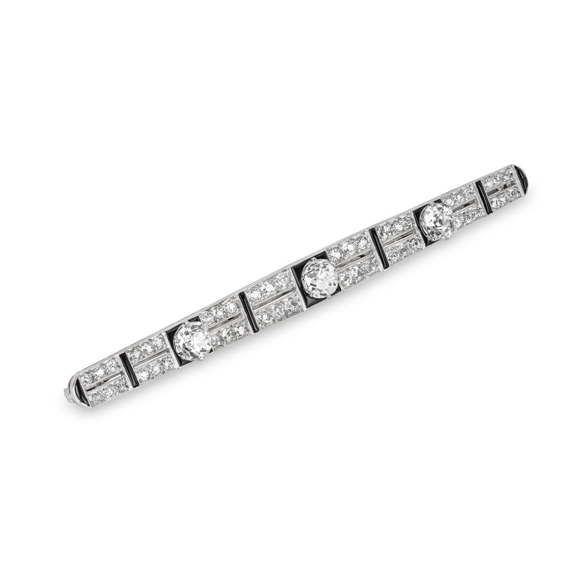 A vintage platinum diamond and onyx brooch circa 1920. The brooch is made up of two rows set with 48 old cut diamonds, joined by intermittent onyx bars. The diamonds have an approximate total weight of 2.95ct, H-J colour and SI-I clarity. Adorning