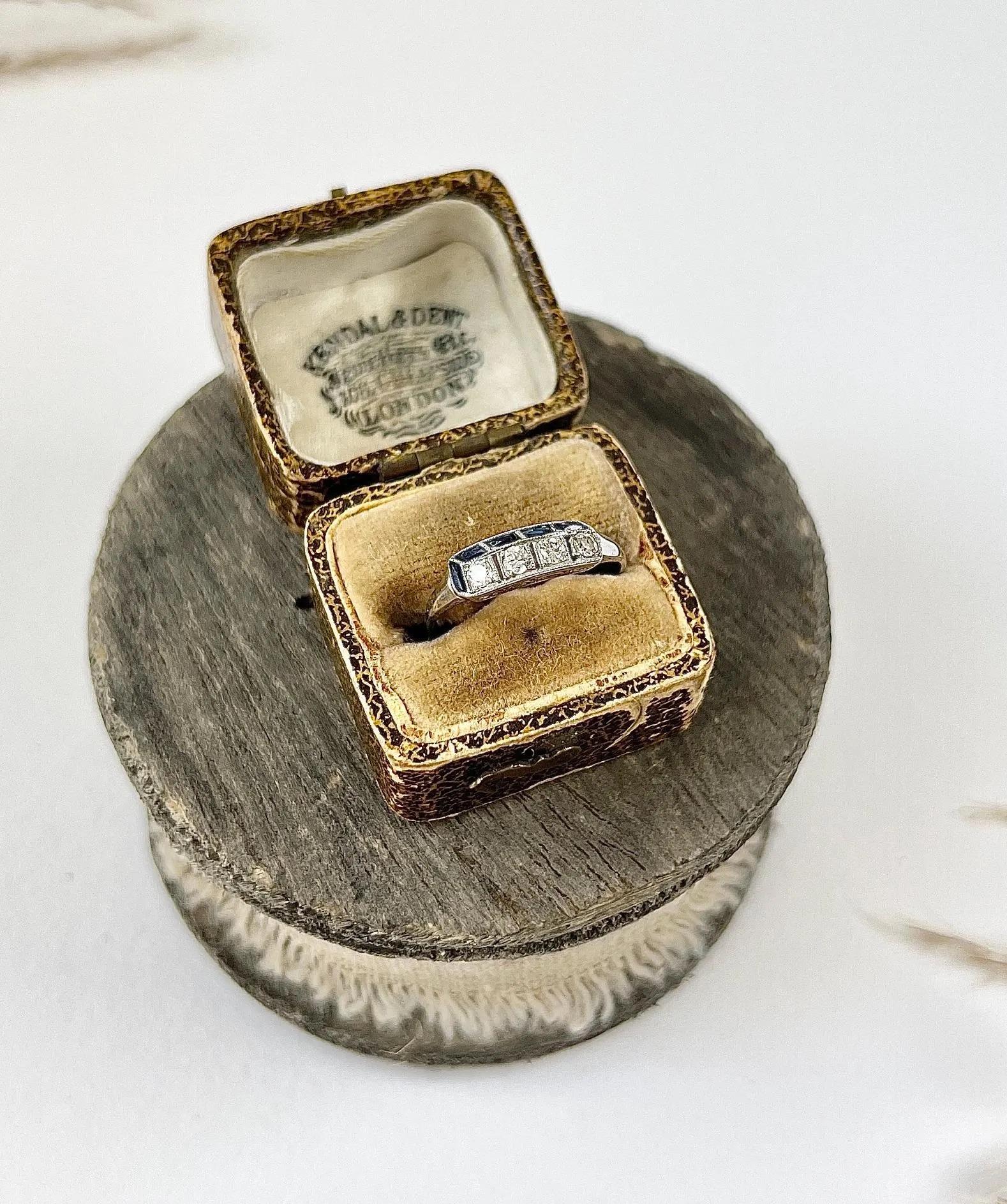 Antique Deco Ring 

Platinum Tested 

Circa 1920s

This exquisite Art Deco platinum ring is a true masterpiece, featuring meticulously set calibrated sapphires and natural diamonds. The impeccable craftsmanship creates a stunning 3D effect, adding