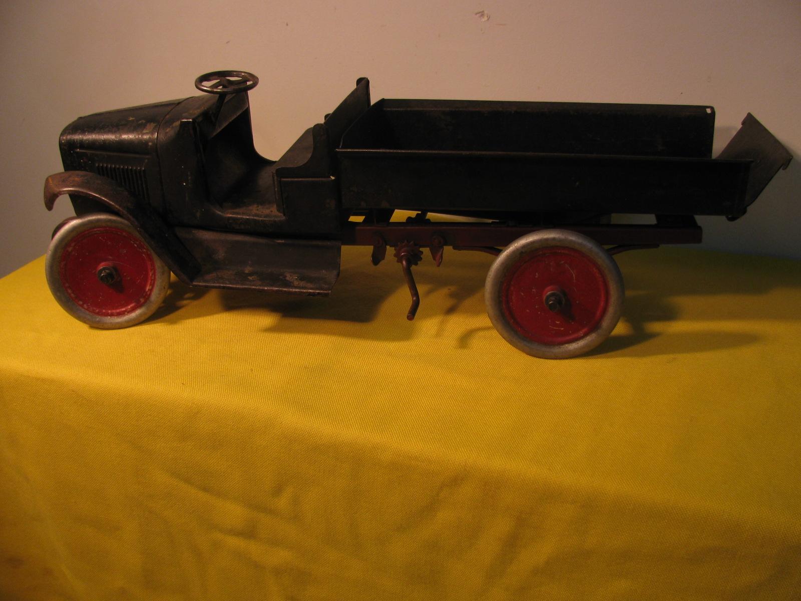 Piece of American History on 4 wheels. Buddy L trucks was the premiere pressed steel toy truck maker back in the day. This open air driver is structurally sound but missing half of a fender and the chain mechanism that would open and lower the dump