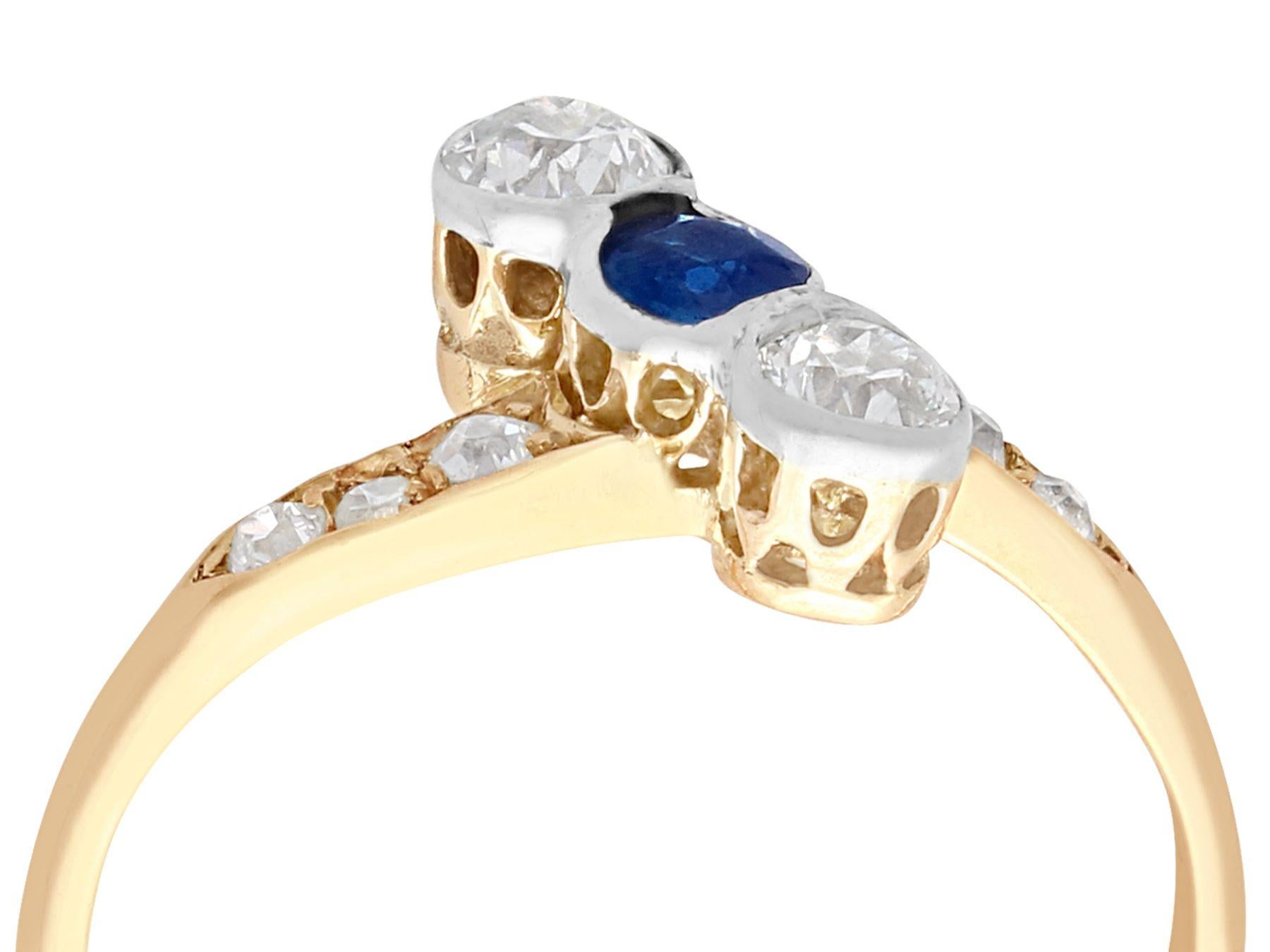 An impressive antique 0.22 carat sapphire and 0.62 carat diamond, 14k yellow gold and 14k white gold set cocktail ring; part of our diverse antique jewelry collections.

This fine and impressive three stone antique ring has been crafted in 14k