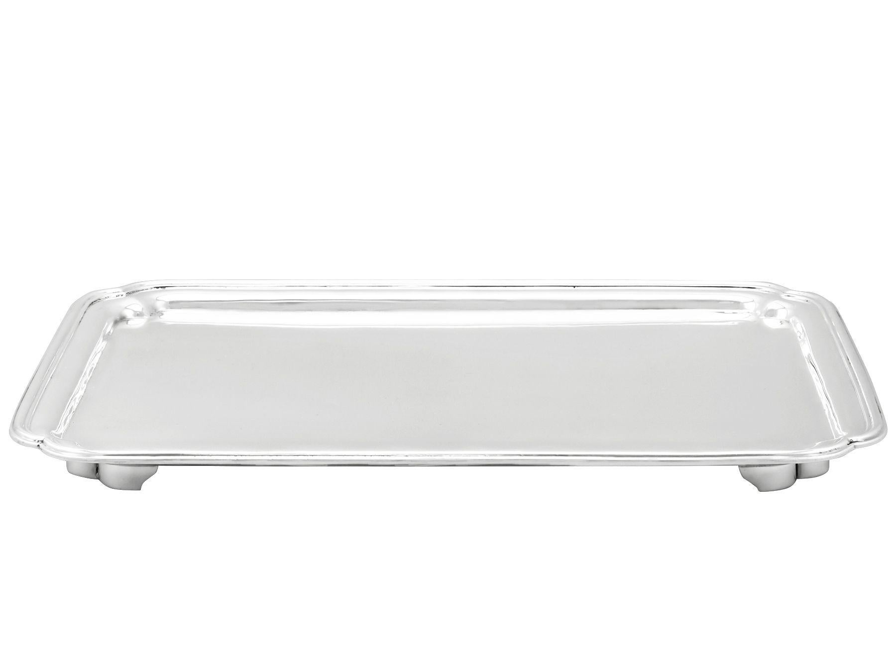 An exceptional, fine and impressive antique Art Deco English sterling silver salver, an addition to our dining silverware collection.

This exceptional antique George V sterling silver salver has a plain rectangular form with incurved shaped